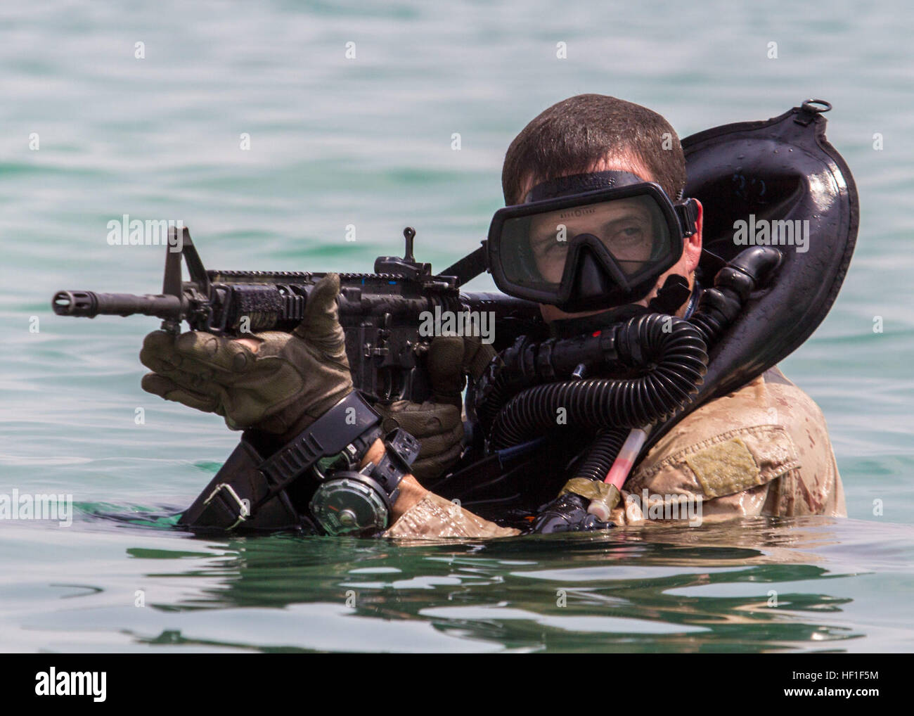 A U.S. Marine assigned to Force Reconnaissance Platoon, Maritime Raid Force, 26th Marine Expeditionary Unit provides security as fellow platoon members conduct an amphibious insertion onto a beach while training foreign marines Sept. 1, 2013, in the U.S. 5th Fleet area of responsibility. Marines with the expeditionary unit, a Marine air-ground task force, were stationed aboard U.S. Navy ships with the Kearsarge Amphibious Ready Group. (DoD photo by Sgt. Christopher Q. Stone, U.S. Marine Corps/Released) 130901-M-SO289-002 (9674183158) Stock Photo