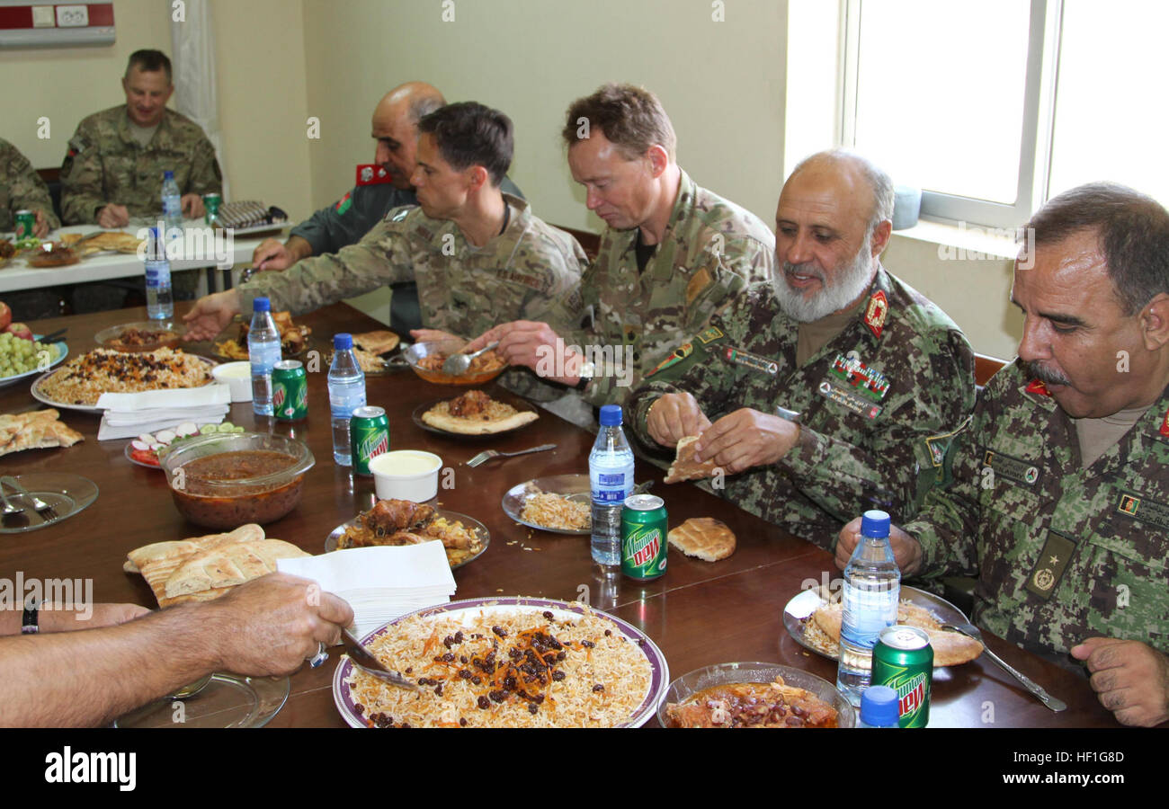 Coalition and Afghan leadership share a meal together following the ribbon cutting ceremony at Kandahar Regional Military Hospital at Camp Hero, Afghanistan, Sept. 25, 2013. The KRMH had spent the last decade working with coalition forces to provide a sufficient military hospital for the ANA as well as civilians in Kandahar province. (U.S. Army photo by Cpl. Clay Beyersdorfer) Afghans take lead with local hospital 130925-Z-HP669-637 Stock Photo