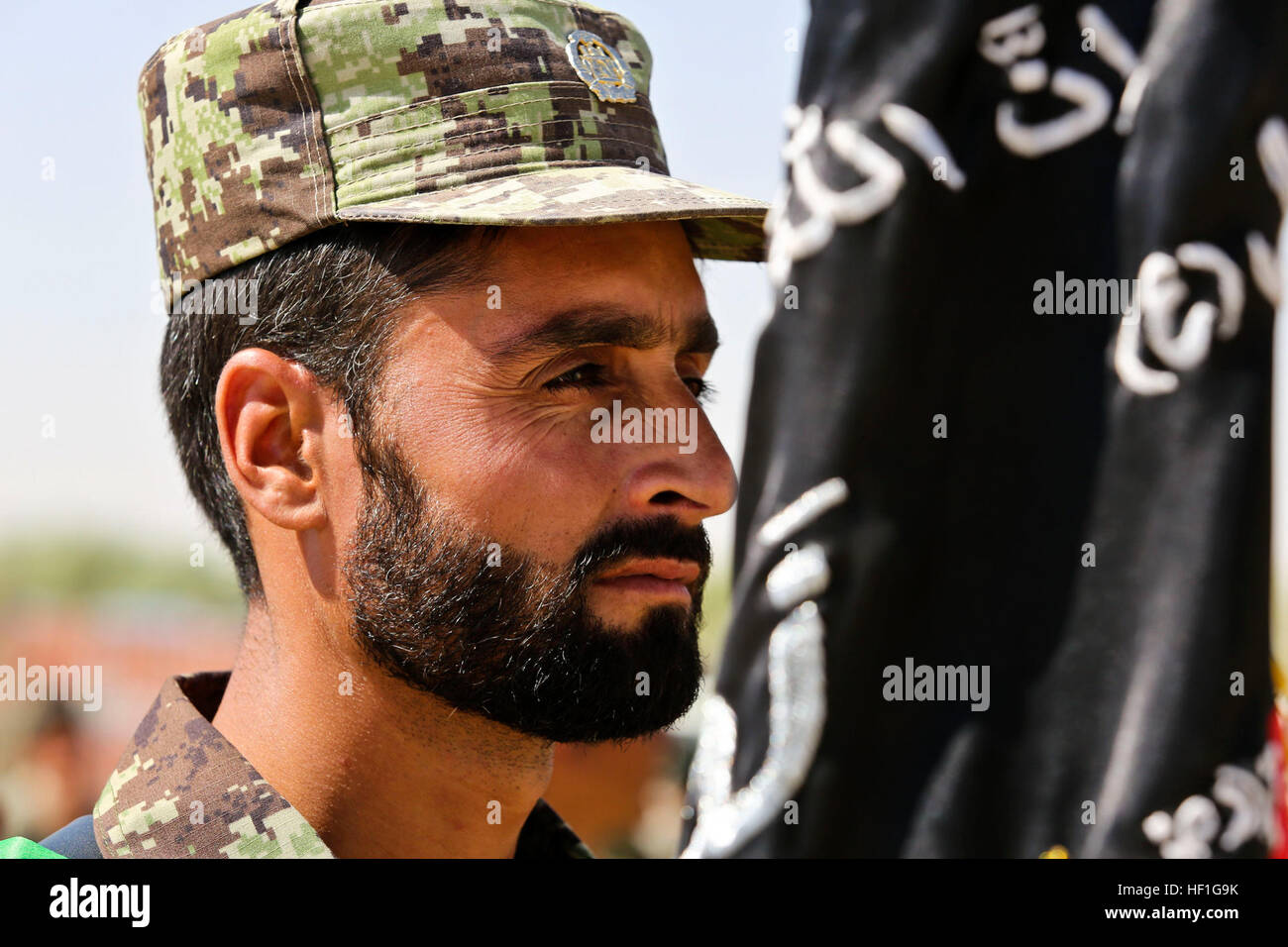 An Afghan Army soldier with the 215th Corps, stands in formation during a ceremony at Camp Shorabak, Helmand province, Afghanistan, Sept. 26, 2013. The soldiers of the 215th Corps celebrated the opening of the Regional Corps Battle School. (U.S. Marine Corps photo by Sgt. Demetrius L. Munnerlyn/Released) Regional Corps Battle School opening 130926-M-ZE445-031 Stock Photo