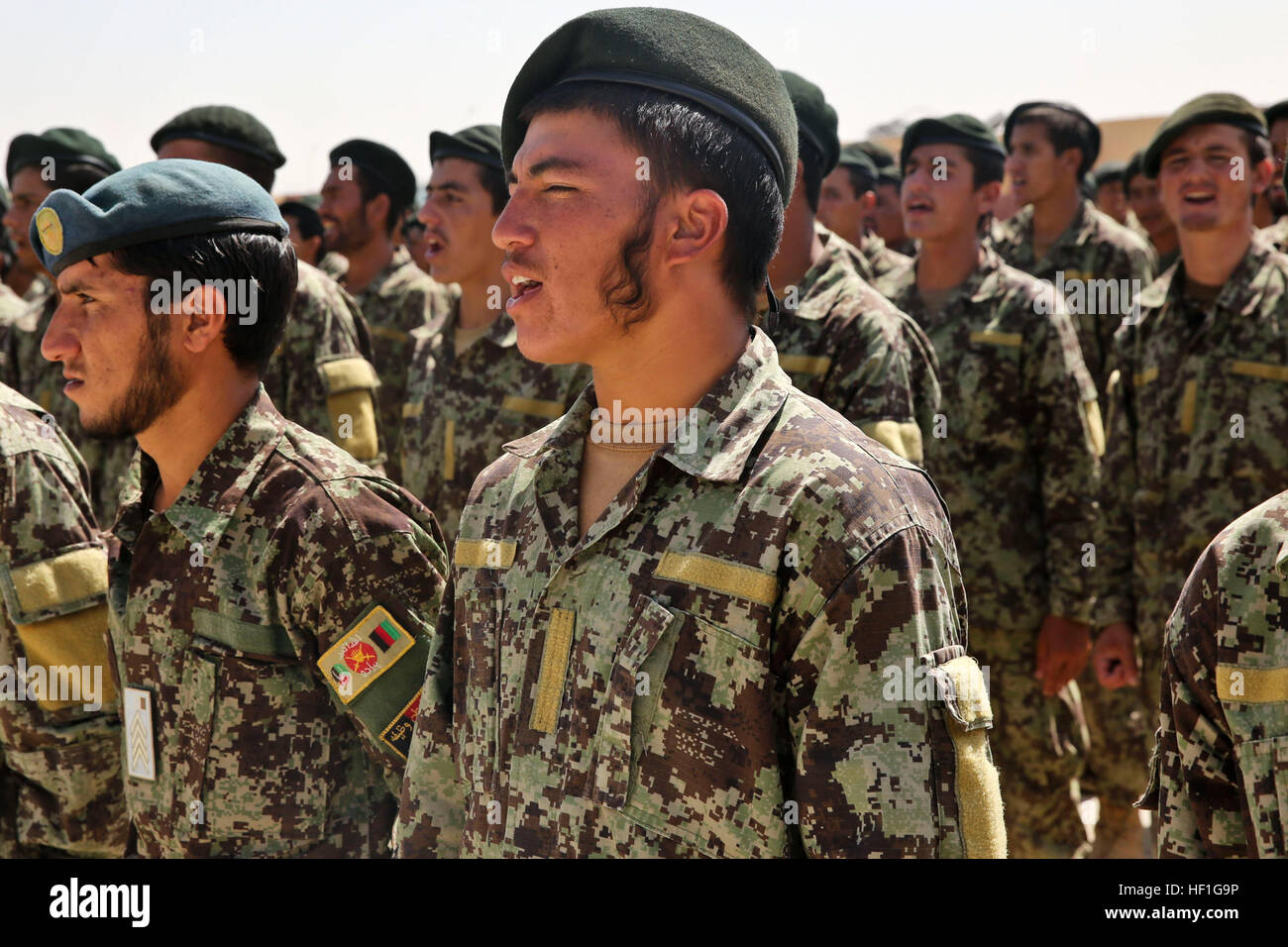 Afghan National Army soldiers with the 215th Corps sing during a ceremony at Camp Shorabak, Helmand province, Afghanistan, Sept. 26, 2013. The soldiers of the 215th Corps celebrated the opening of the Regional Corps Battle School. (U.S. Marine Corps photo by Sgt. Demetrius L. Munnerlyn/Released) Regional Corps Battle School opening 130926-M-ZE445-098 Stock Photo