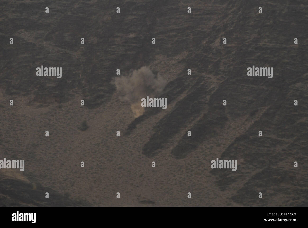 A high explosive mortar shell hits its target after being fired from a M224 60mm mortar on Forward Operating Base Torkham, Sept. 27, 2013. Soldiers from Company C, 2nd Battalion, 30th Infantry Regiment, 4th Brigade Combat Team, 10th Mountain Division conducted live fire training to ensure that their skills remain sharp. As part of their training they fired both illumination and high explosive shells. Their target was a deserted mountainside outside their base. Before each mortar shell was fired, the Soldiers scanned the area to make sure that no living creature was nearby. (U.S. Army National  Stock Photo