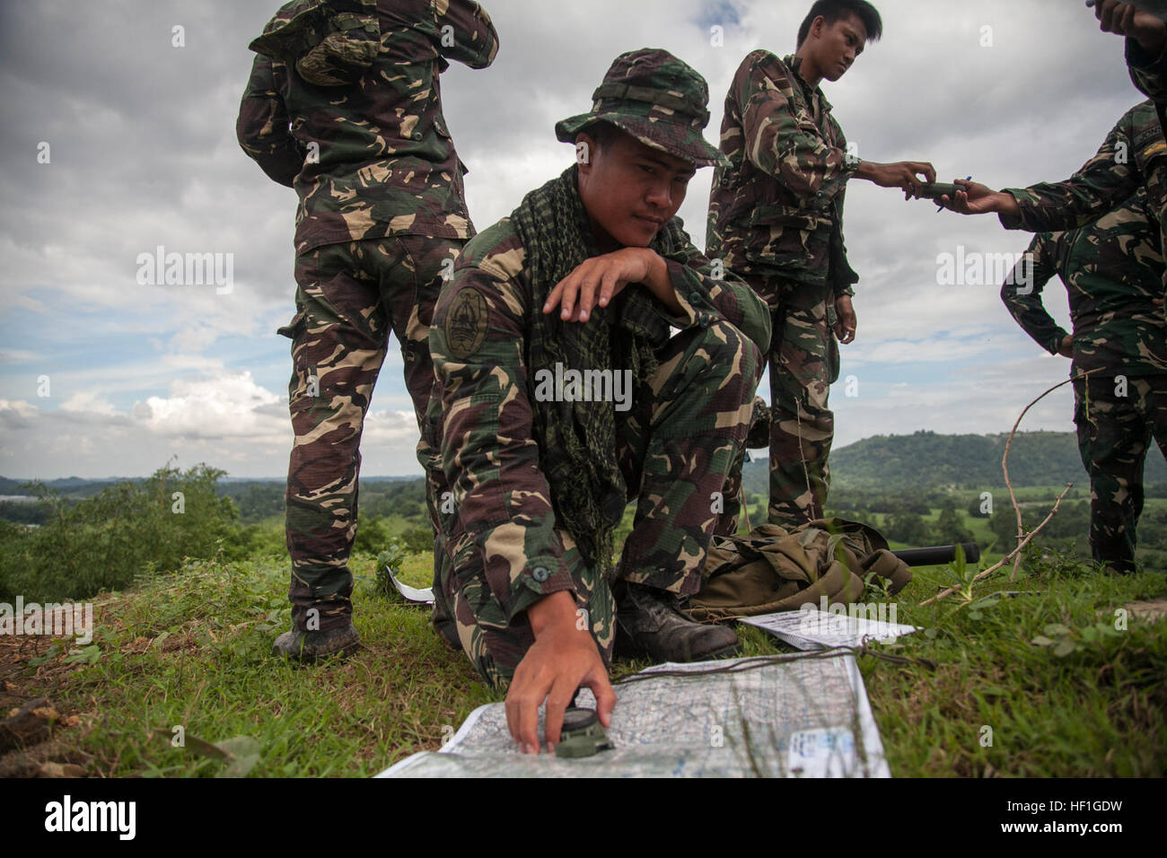 Philippine Airman 2nd Class Jivo Brasileno plots targets during close air support training Sept. 29 at Crow Valley, Republic of the Philippines part of Amphibious Landing Exercise 2014. The day of training qualified the participating Philippine Air Force members as forward air controllers. Bilateral training during PHIBLEX 14 is focused on enhancing interoperability and the readiness of forces. Brasileno is a forward air controller with 710th Special Operations Wing. U.S. Marines and sailors from the 13th Marine Expeditionary Unit, 3d Marine Expeditionary Brigade and III Marine Expeditionary F Stock Photo