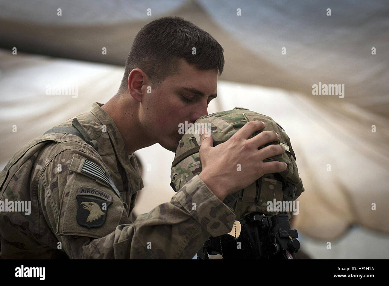 U.S. Army Spc. Brit B. Jacobs, a combat medic from Sarasota, Fla., assigned to Company C, 2nd Battalion, 327th Infantry Regiment, Task Force No Slack, 1st Brigade Combat Team, 101st Airborne Division, gives a farewell kiss to the helmet of one of his fallen comrades during a memorial service for six fallen U.S. soldiers at Forward Operating Base Joyce in eastern Afghanistan's Kunar province April 9. Jacobs helped treat some of the wounded on the battlefield when six of his brethren died, March 29. Flickr - DVIDSHUB - Six TF No Slack soldiers remembered (Image 3 of 3) Stock Photo