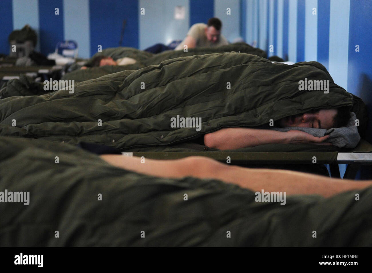 Airmen sleep in cots at the Falcon Fitness Center on Aviano Air Base, Italy, March 22. U.S. Air