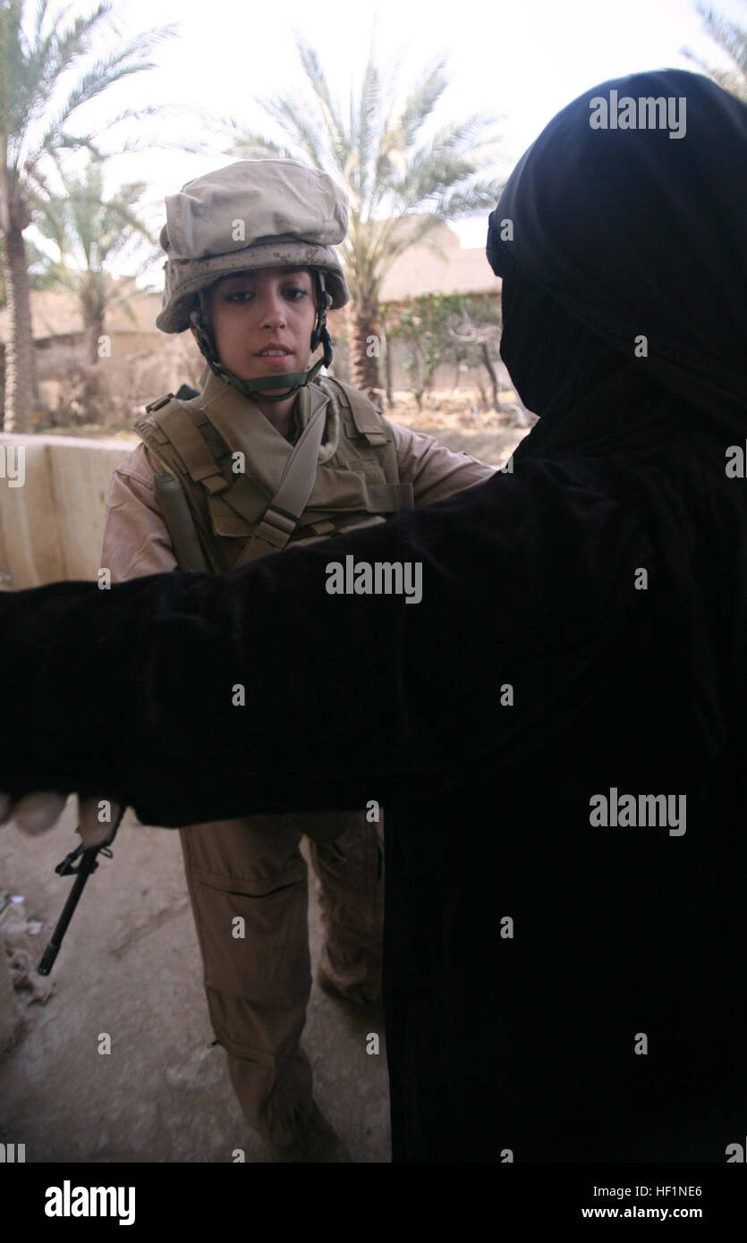 Cpl. Nancy P. Hernandez, a 23-year-old from The Colony, Texas, searches a  woman during a Cooperative Medical Engagement event in as-Saqlawiyah, Iraq,  Feb. 29. The event took place at the village schoolhouse