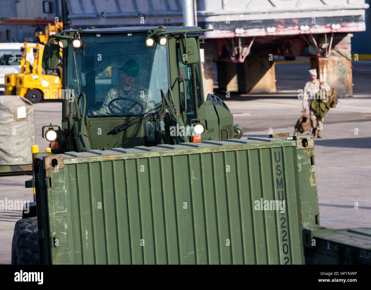 Shipping containers are transported after being inspected by U.S ...
