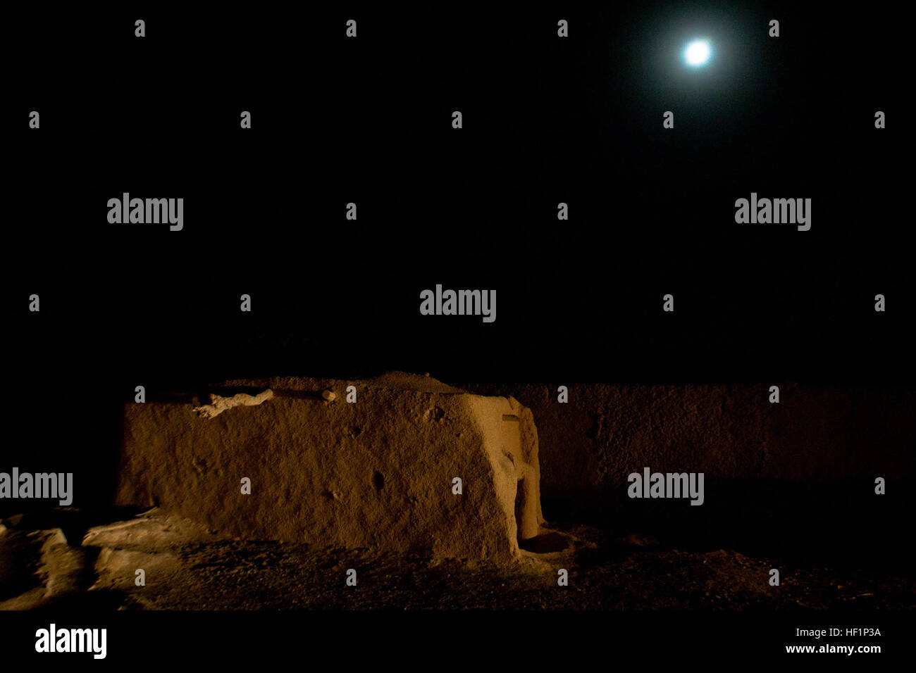 The moon rises over a desert compound near Forward Operating Base Shir