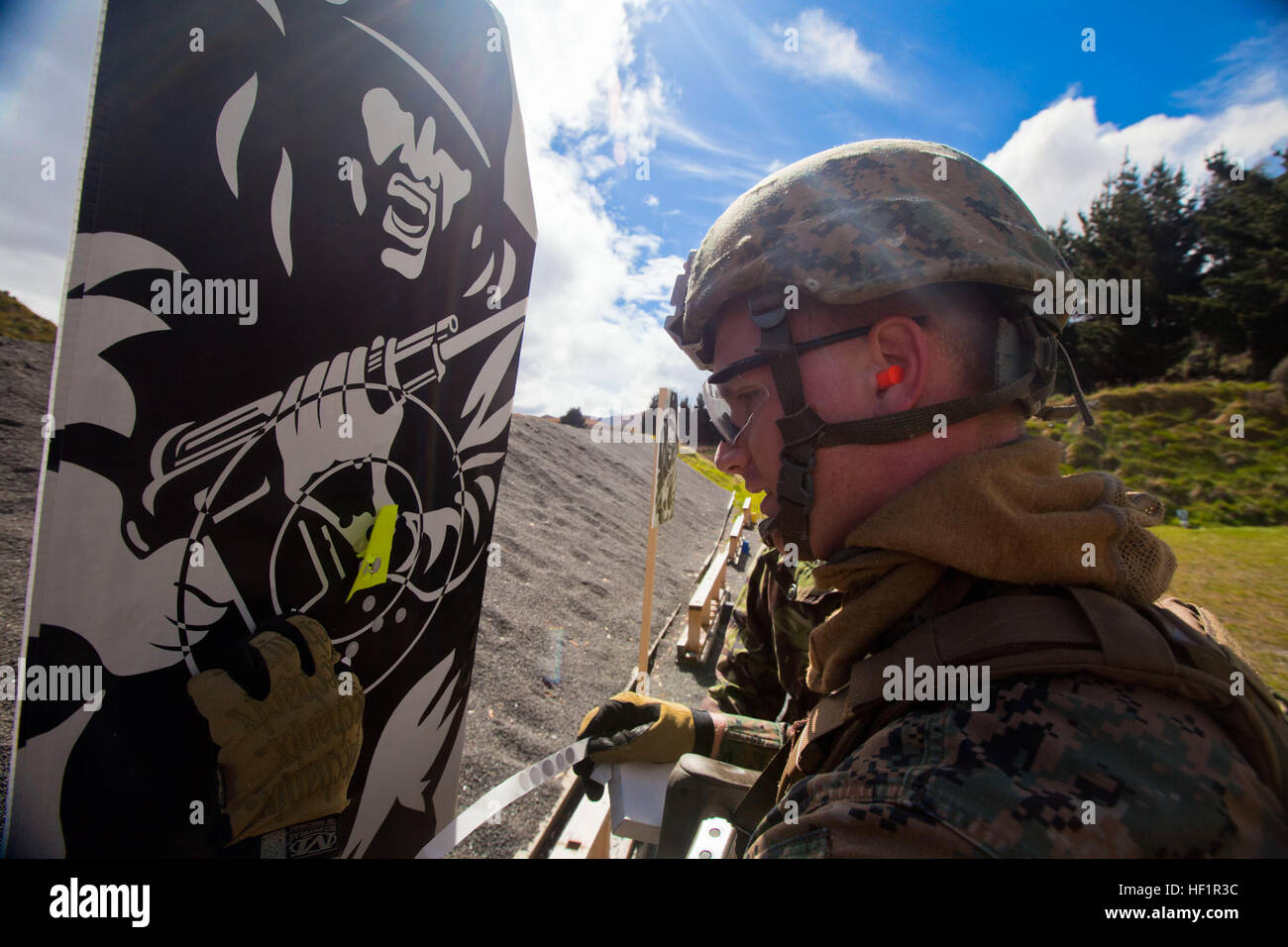 Cpl. Thomas Cornwall, military policeman with 1st Law Enforcement Battalion, from Ventura, California, re-marks his target during a familiarization shooting range with the Individual Weapon (IW) Steyr assault rifle during the initial stages of exercise Southern Katipo 2013 at Waiouru Military Camp, New Zealand, Nov. 7. SK13 strengthens military-to-military relationships and cooperation with partner nations and the New Zealand Defence Force. Personal Protection Team of SK13 puts rounds down range 131107-M-SE196-007 Stock Photo