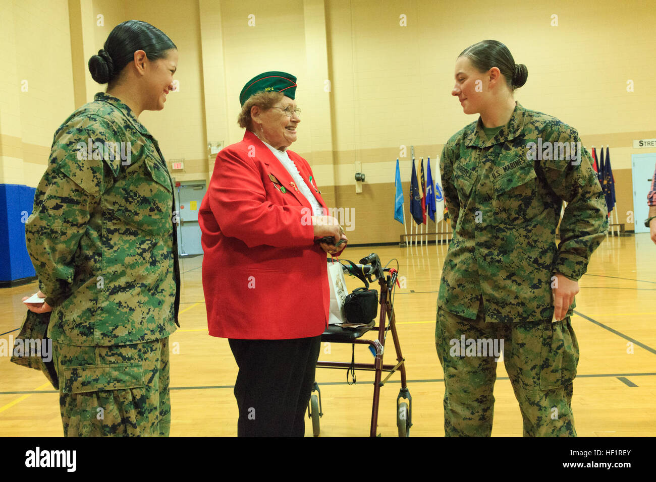 Pfc. Cristina Fuentes Montenegro, 25, one of the first three female Marine graduates from the School of Infantry-East’s Infantry Training Battalion course, and native of Coral Springs, Florida, left, and Pfc. Julia Carroll, 18, one of the first three female Marine graduates from the School of Infantry-East’s Infantry Training Battalion course, and native of Idaho Falls, Id., far right, visit with Shirley M. John from the North Carolina Tarheel Chapter of the Women Marines Association following the graduation ceremony of Delta Company, Infantry Training Battalion, School of Infantry-East at Cam Stock Photo