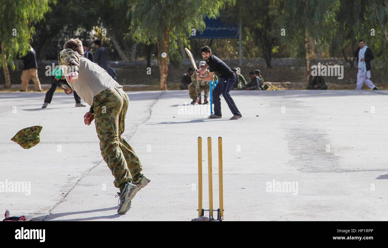 A soldier of the 205th Coalition Advisory Team hurls a ball during a game of cricket against soldiers of the 205th Hero Corps, Afghan National Army, at Camp Hero, Kandahar province, Afghanistan, Nov. 21, 2013. Coalition advisory teams have played the ANA in various sporting events since coming to Afghanistan in 2010. (U.S. Army photo by Cpl. Clay Beyersdorfer) Two legs to stand on 131121-Z-HP669-002 Stock Photo