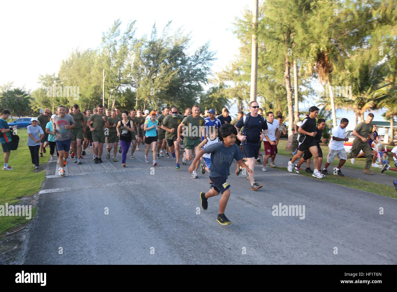 Participants in the 2nd Tinian Hafa Adai 5 kilometer run take off sprinting Nov. 30, after the start buzzer rang. More than 120 runners participated in the event with Marines, sailors and locals running together. The Marines are with Marine Wing Support Squadron 171, Marine Aircraft Group 12, 1st Marine Aircraft Wing, III Marine Expeditionary Force. The service members currently on Tinian participating in Exercise Forager Fury II, which is a joint exercise, designed to employ and assess combat power generation in a deployed and austere environment. (U.S. Marine Photo by Cpl. J. Gage Karwick/Re Stock Photo