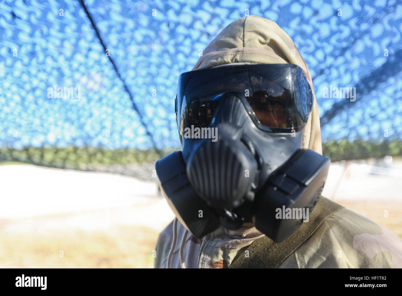 U.S. Marine Corps Sgt. Garret Arrieta, a chemical, biological, radiological, nuclear defense (CBRND) specialist with Marine Aircraft Group 12 poses with an M50 gas mask as part of a CBRND training exercise on North Field, Tinian, Northern Mariana Islands during exercise Forager Fury II, Dec. 3, 2013. This CBRND exercise is used to train Marines on the procedures of how to act and react in a contaminated environment. (U.S. Marine Corps photo by Lance Cpl. Austin Schlosser/Released) Forager Fury II 131203-M-MP631-028 Stock Photo