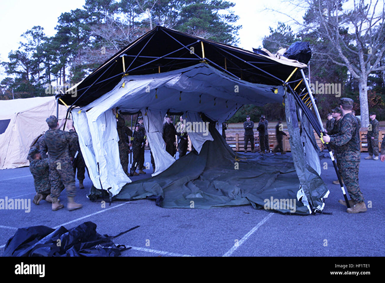 Sailors with 2nd Dental Battalion, 2nd Marine Logistics Group, assemble a tent during an Authorized Dental Allowance List exercise aboard Camp Lejeune, N.C., Dec. 6, 2013. Once assembled, sailors disassembled the tent and participated in a walk-through instruction of expeditionary equipment and field exam procedures. (U.S. Marine Corps photo by Lance Cpl. Shawn Valosin) ADAL EX forces service members out of their comfort zones 131206-M-IU187-049 Stock Photo