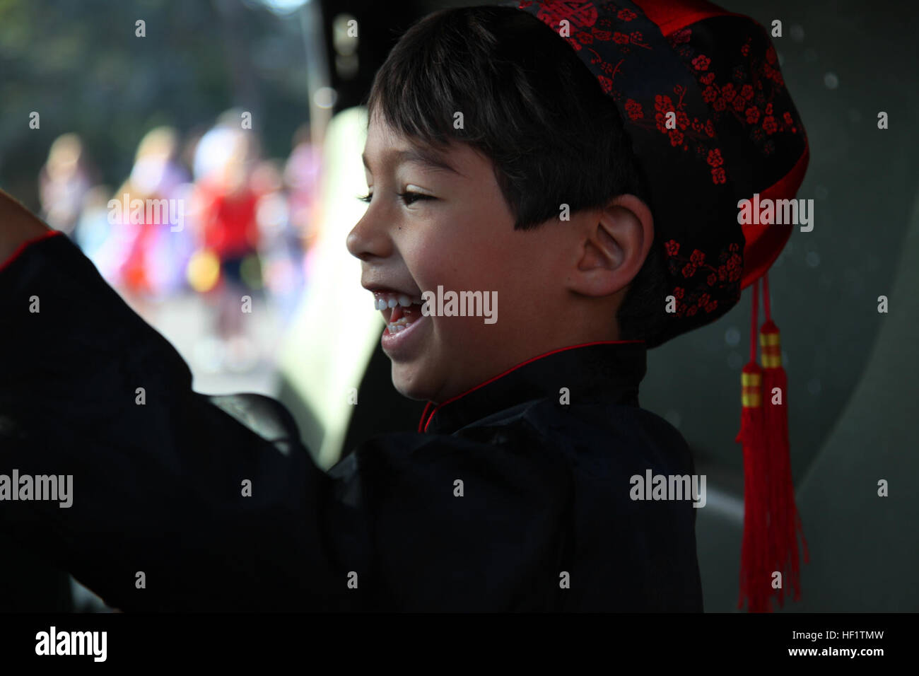 A young boy laughs as he honks the horn of a Humvee at the 2011 Mission