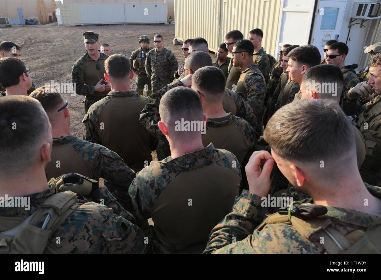 U.S. Marine Corps Capt. Thomas Wallin briefs his Marines and Sailors at Camp Lemonnier, Djibouti, Dec. 24, 2013. The Special-Purpose Marine Air-Ground Task Force Crisis Response recently repositioned from Moron Air Base, Spain. It trains for a variety of missions as directed by national and command authorities, but it remains focused on deterring crises throughout the U.S. Africa Command area of responsibility. Wallin is a ground combat element commander. (U.S. Marine Corps photo by Staff Sgt. Robert L. Fisher III.) U.S. Marines reposition from Spain 131224-M-HF911-001 Stock Photo