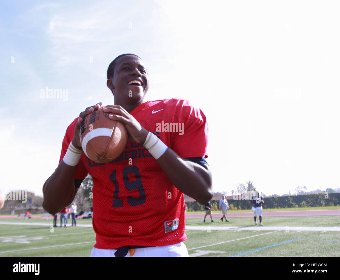 Fulerton, Calif. - Quentin Gibson, quarterback for the Semper Fidelis All-American Bowl East Team smiles before throwing a football to his teammate, Jan. 3, 2014. The Semper Fidelis All-American Bowl will be held on Jan. 5, 2014, at 6 p.m. PST in Carson, Calif., at The StubHub Center and aired live on Fox Sports 1. (Official U.S. Marine Corps photo by Sgt. Andres J. Lugo/Released) Semper Fidelis All-American Football Practice 140103-M-QG862-019 Stock Photo
