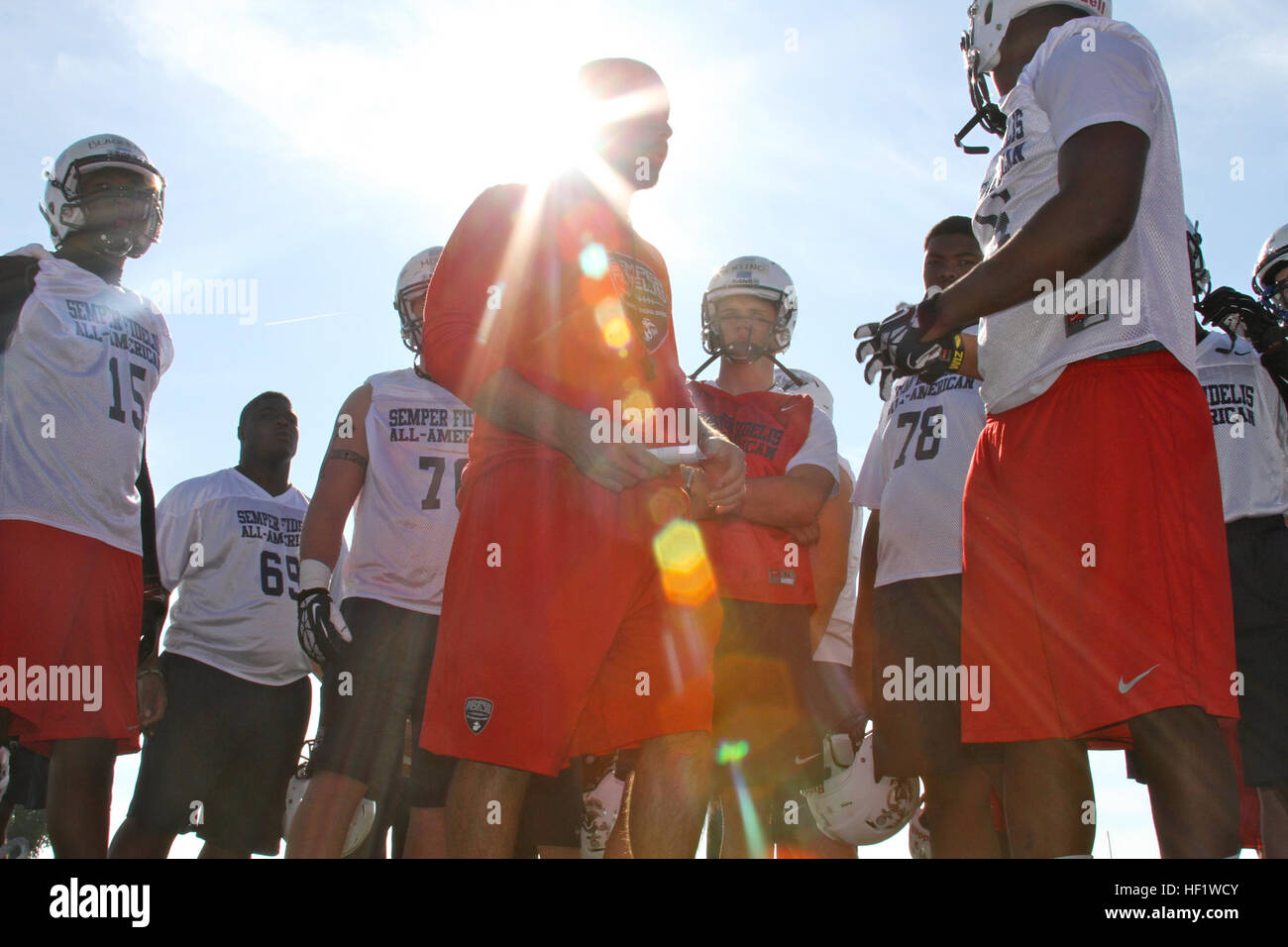 Christopher Merritt speaks to members of the Semper Fidelis All-American Bowl East team at the conclusion of practice at Fullerton College in Fullerton, Calif., Jan. 4. Merritt, a high school football coach from Columbus High School in Miami, Fla., is the head football coach for the East team. The Semper Fidelis All-American Bowl is unique because the players are among the most talented players in the nation and are high-academic performers and leaders in their communities. The 2014 Semper Fidelis All-American Bowl will be held on Jan. 5 at 6 p.m. in Carson, Calif. The game will be played at t Stock Photo