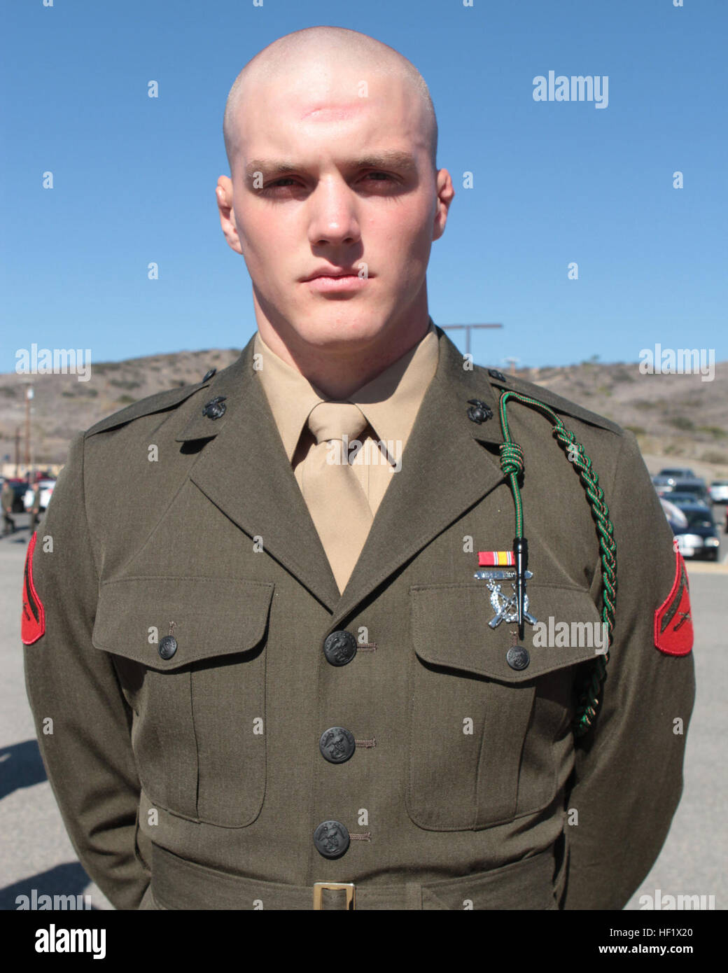 A machine gunner with Golf Company, 2nd Battalion, 4th Marine Regiment,  assigned to the 5th Marine Regiment, receives the French Fourragre during  a ceremony at Camp Pendleton, Calif., Jan. 22, 2014. The