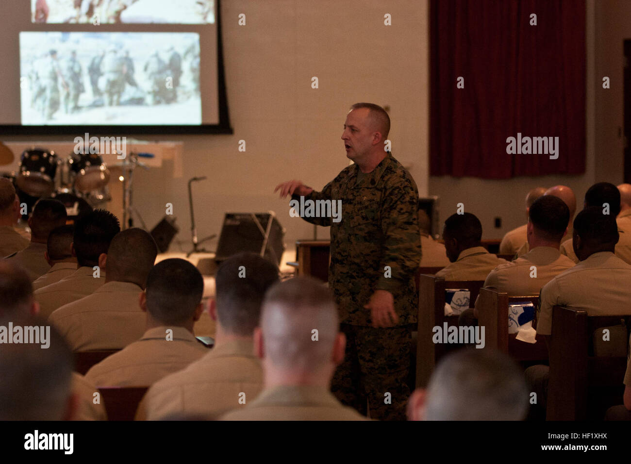 Sgt. Maj. Justin D. Lehew speaks with students and faculty participating in the Staff Non-Commissioned Officers Academy Feb. 6 at the West Chapel on Camp Hansen regarding his personal experiences in the Marine Corps and how those in attendance can expand their knowledge of history and tradition. Lehew earned the Navy Cross, the second highest award for combat valor after the Medal of Honor, for his actions March 23-24, 2003 during the Battle of An-Nasiriyah. The battle took place during the initial invasion of Iraq, in support of Operation Iraqi Freedom. Lehew is the command sergeant major of  Stock Photo