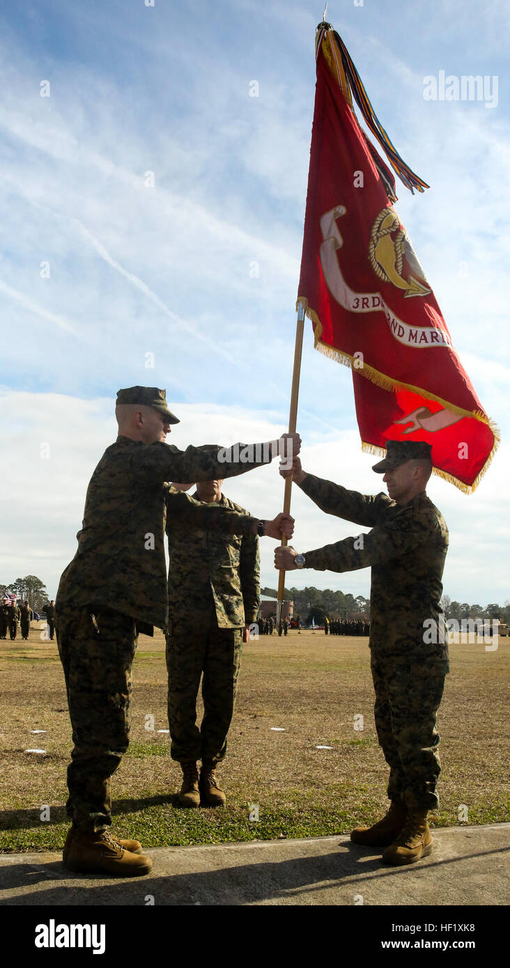 Lieutenant Col. Charles R. Cassidy passes the battalion's colors to Col. Tim Powers at William Pendleton Thompson Hill Field Feb. 6, 2014, signifying the changing of command and the passing of responsibilities. 'You have set the bar high, but we will try our best to meet the standard you have set,' said Powers while addressing the Marines, as the new Commanding Officer. 3rd Battalion 2nd Marines gets new CO 140206-M-WI309-021 Stock Photo