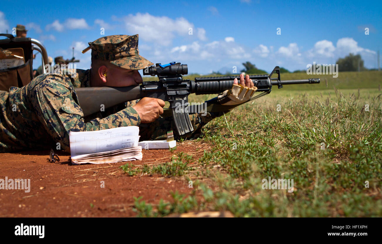 U.S. Marine Corps Lance Cpl. Logan Gray, a team leader assigned to 3rd Battalion, 3rd Marine Regiment, fires down range during the Pacific Division Shooting Matches at Puuloa Range Training Facility near Ewa Beach, Feb. 10th, 2014. The Pacific Division Shooting Match is one of four division matches throughout the Marine Corps in which U.S. service members and the Pacific's best shooters participate in a small arms marksmanship competition each year. (U.S. Marine Corps photo by Lance Cpl. Aaron S. Patterson, MCBH Combat Camera/Released) PacDiv 2014 140210-M-QH615-027 Stock Photo
