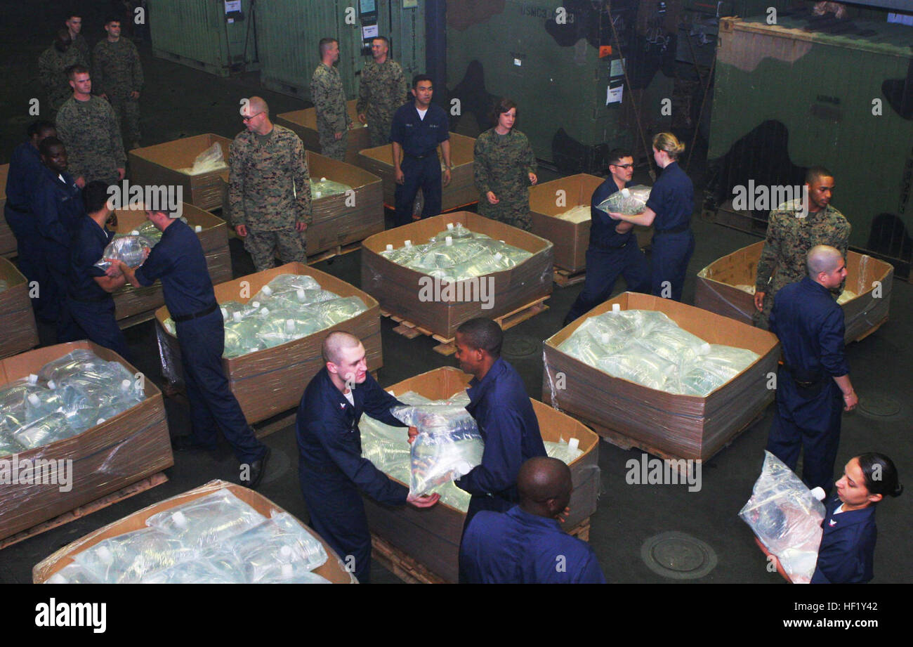 May 16, 2008, Sailors and Marines aboard the USS Essex (LHD 2) fill boxes with 16-liter water bladders in preparation for possible humanitarian assistance. The Essex group is within 35 nautical miles off the coast of Burma waiting for clearance to participate in humanitarian assistance operations in the wake of Cyclone Nargis. (U.S. Marine Corps photo/Lance Cpl. Audrey M. Graham) Sailors and Marines prepare for possible humanitarian assistance DVIDS89853 Stock Photo