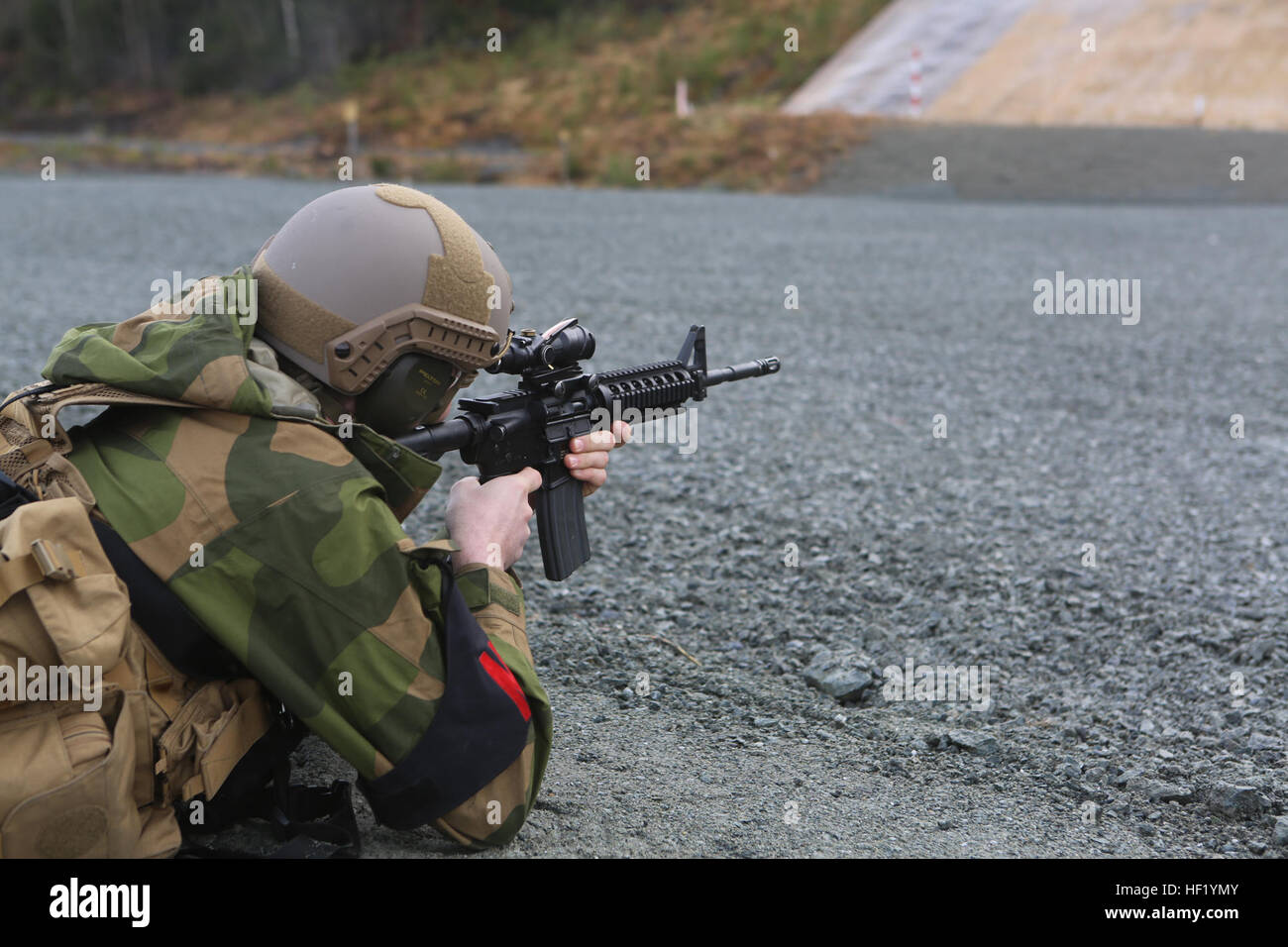 Cpl. Robert T. Kolberg, a Roros, Norway, native and military policeman with Home Guard District 12 prepares to fire an M-4 belonging to a military policeman with 2nd Supply Battalion, Combat Logistics Regiment 25, 2nd Marine Logistics Group at a firing range at Frigaard, Norway, Feb. 25, 2014. The MPs from both nations used their time together as an opportunity to learn about each other’s operations, equipment and weapons before Cold Response 2014. Cold Response 2014 is a Norwegian-led multinational exercise above the Arctic Circle designed prepare for crisis response operations. Cold calculat Stock Photo