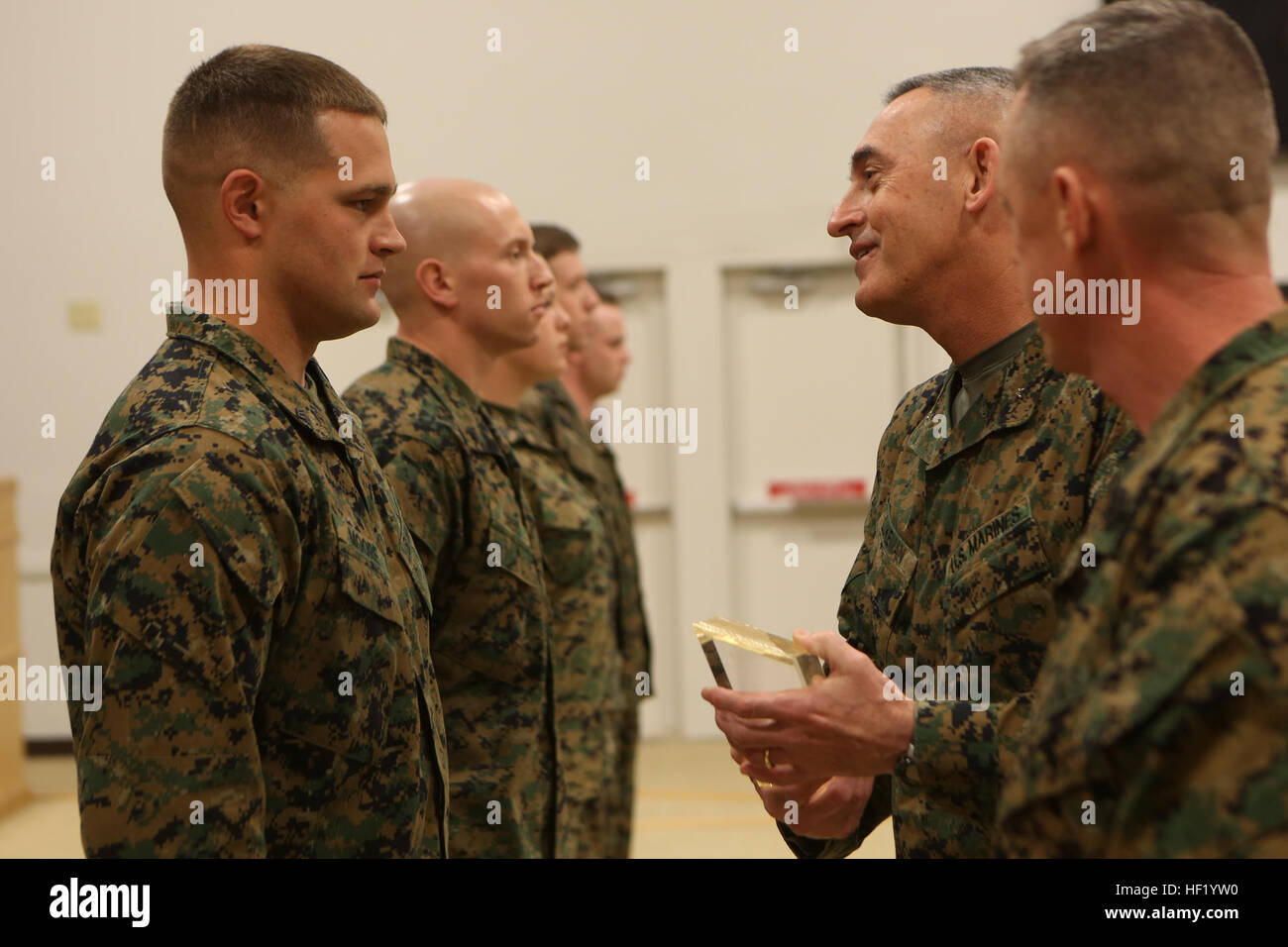 Brigadier Gen. James W. Lukeman, the 2nd Marine Division commanding general, congratulates Sgt. Joshua L. Moore, with 2nd Battalion, 8th Marine Regiment, 2nd Marine Division, for his accomplishment in receiving the Gunnery Sergeant John Basilone Award during the Morning Awards Ceremony Feb. 27, 2014 aboard Marine Corps Base Camp Lejeune. The award is presented to Marines who exhibit Basilone's attributes, such as courage and commitment. Marines, sailors awarded for outstanding performances 140227-M-BW898-009 Stock Photo