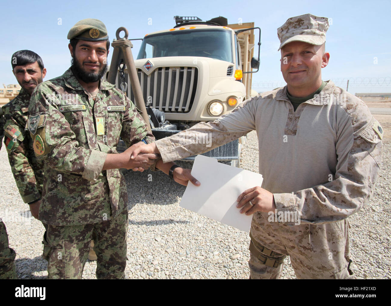 Staff Sgt. Mohammed Nasim Safai, left, accepts the documentation of ...