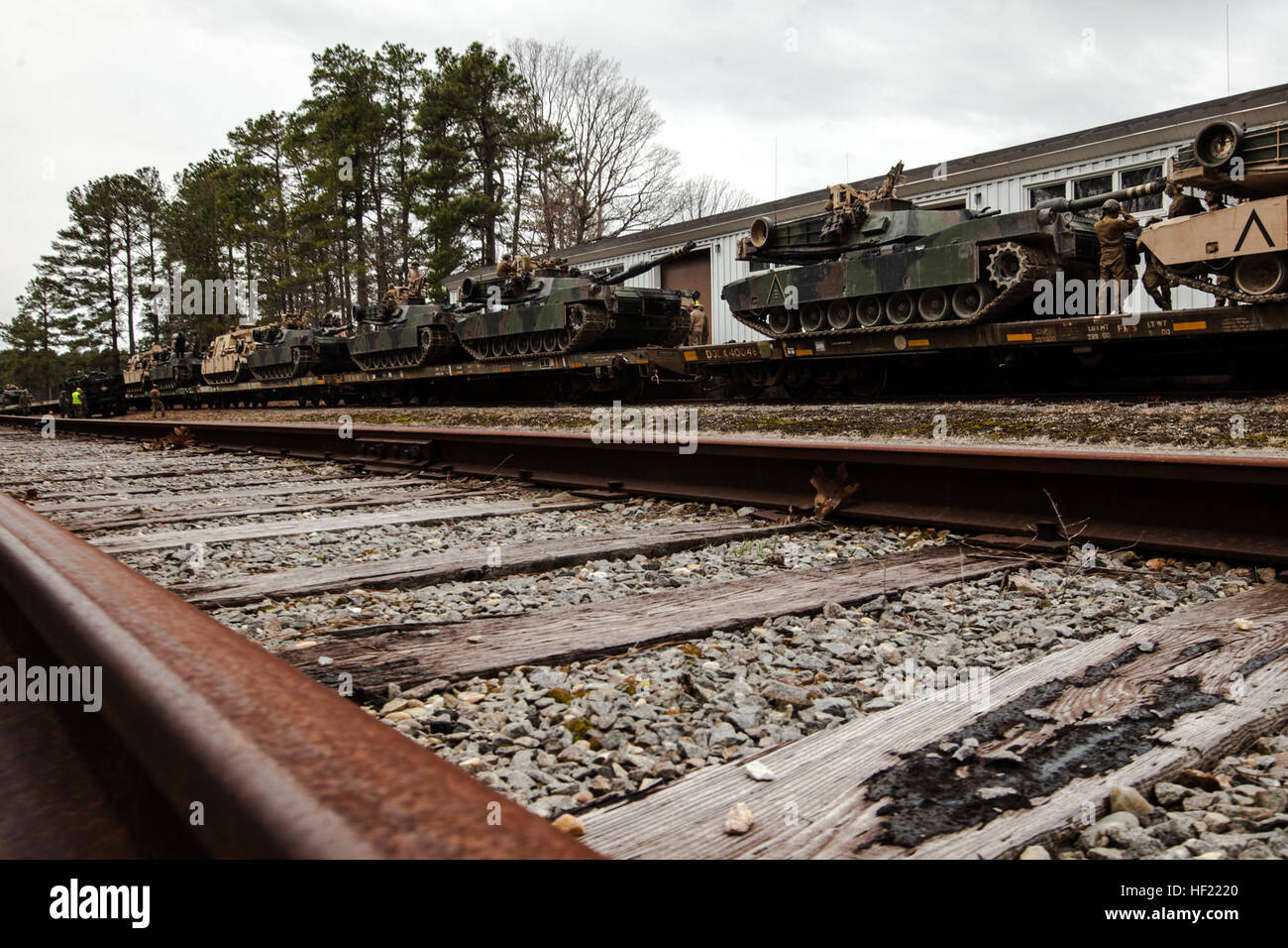 U.S. Marine Corps M1A1 Abrams tanks and M88 A2 Hercules Recovery Vehicles are prepared to be unloaded from railcars during a Deployment for Training (DFT) Exercise at Fort Pickett, Va., March 28, 2014. The DFT is conducted to strengthen the unit's proficiency in a combat environment.  (U.S. Marine Corps photo by Lance Cpl. Kelly Timney, 2nd MarDiv, Combat Camera/Released) 2nd Tank Battalion Deployment for Training Exercise (DFT) 140328-M-OU200-223 Stock Photo