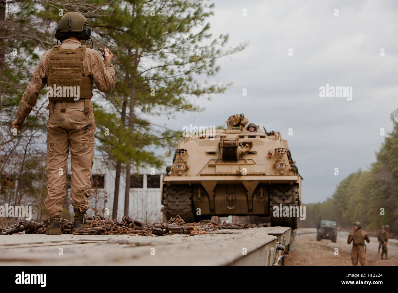 U.S. Marine Corps Cpl. Ryan Goetts, a vehicle commander, 2nd Tank Battalion, 2nd Marine Division, ground guides an M88 A2 Hercules Recovery Vehicle off railcars during a Deployment for Training (DFT) Exercise at Fort Pickett, Va., March 28, 2014. The DFT is conducted to strengthen the unit's proficiency in a combat environment.  (U.S. Marine Corps photo by Lance Cpl. Kelly Timney, 2nd MarDiv, Combat Camera/Released) 2nd Tank Battalion Deployment for Training Exercise (DFT) 140328-M-OU200-249 Stock Photo