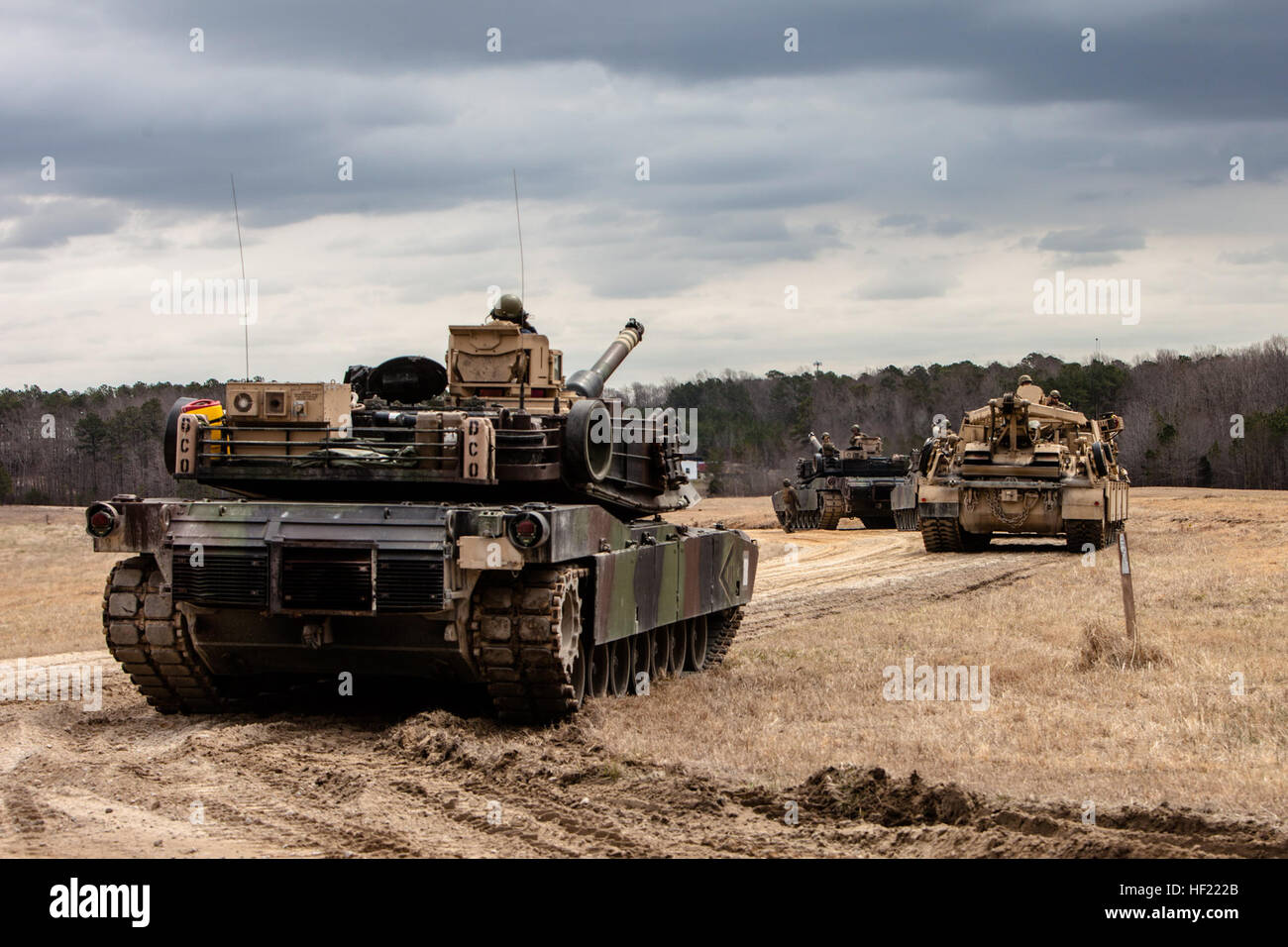 U.S. Marine Corps M1A1 Abrams tanks and an M88 A2 Hercules Recovery Vehicle roll out from the railhead to the tank ramp during a Deployment for Training (DFT) Exercise at Fort Pickett, Va., March 28, 2014. The DFT is conducted to strengthen the unit's proficiency in a combat environment.  (U.S. Marine Corps photo by Lance Cpl. Kelly Timney, 2nd MarDiv, Combat Camera/Released) 2nd Tank Battalion Deployment for Training Exercise (DFT) 140328-M-OU200-273 Stock Photo