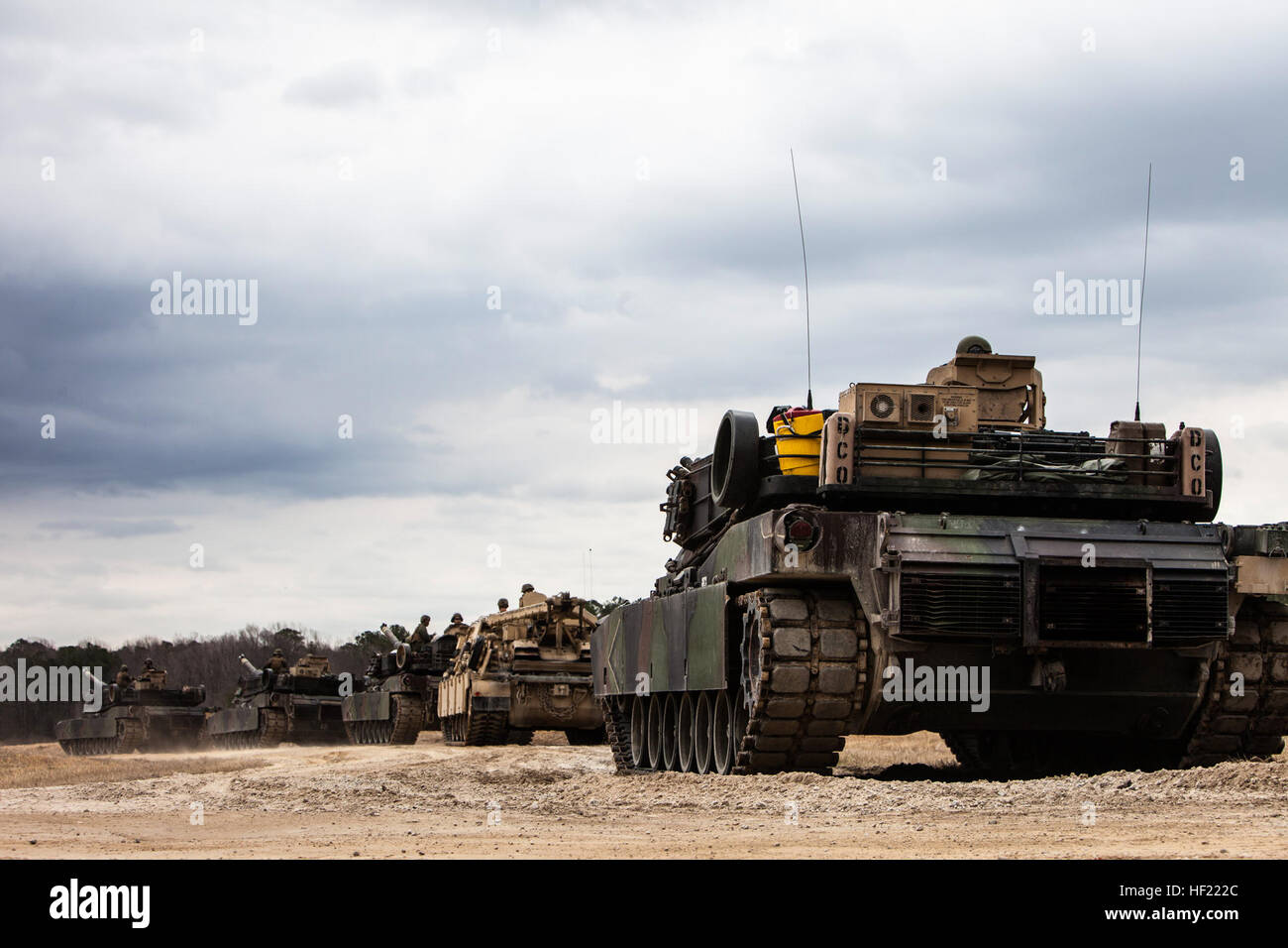 U.S. Marine Corps M1A1 Abrams tanks and an M88 A2 Hercules Recovery Vehicle roll out from the railhead to the tank ramp during a Deployment for Training (DFT) Exercise at Fort Pickett, Va., March 28, 2014. The DFT is conducted to strengthen the unit's proficiency in a combat environment.  (U.S. Marine Corps photo by Lance Cpl. Kelly Timney, 2nd MarDiv, Combat Camera/Released) 2nd Tank Battalion Deployment for Training Exercise (DFT) 140328-M-OU200-279 Stock Photo
