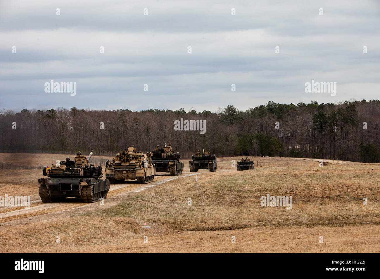 U.S. Marine Corps M1A1 Abrams tanks and an M88 A2 Hercules Recovery Vehicle roll out from the railhead to the tank ramp during a Deployment for Training (DFT) Exercise at Fort Pickett, Va., March 28, 2014. The DFT is conducted to strengthen the unit's proficiency in a combat environment.  (U.S. Marine Corps photo by Lance Cpl. Kelly Timney, 2nd MarDiv, Combat Camera/Released) 2nd Tank Battalion Deployment for Training Exercise (DFT) 140328-M-OU200-308 Stock Photo