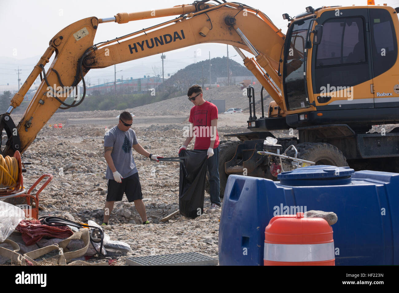U.S. Marine Corps Lance Cpls. Gregory Kern and Christopher Major, both embarkation specialists with the III Marine Expeditionary Force, pick up trash during a community service project March 28, 2014, at Ocheon Stream in Pohang, South Korea, as part of exercise Ssang Yong 2014. Ssang Yong is a combined U.S.-South Korean combat readiness and joint/combined interoperability exercise designed to advance South Korean command and control capabilities through amphibious operations. (U.S. Marine Corps photo by Cpl. Sara A. Medina/Released) U.S. Marine Corps Lance Cpls 140328-M-RN526-075 Stock Photo