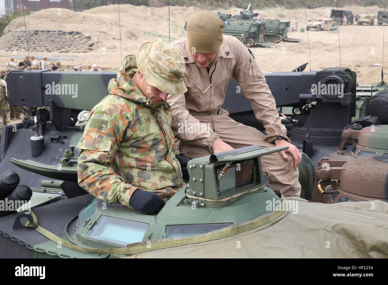 U.S. Marine Cpl. Kyle Eaton, right, shows Australian Army Pvt. Ted Hanlon controls in the turret of an amphibious assault vehicle during exercise Ssang Yong 2014 March 30 in Dogue, Republic of Korea. Ssang Yong 14 is a combined amphibious exercise, incorporating more than 13,000 U.S. and ROK Navy-Marine and Australian Army forces, which effectively demonstrates the unique abilities of a forward-deployed Marine air-ground task force. Hanlon is an infantryman with Company B, 6th Battalion, Royal Australian Regiment. Eaton is an amphibious assault vehicle crewman with 3rd Assault Amphibian Battal Stock Photo
