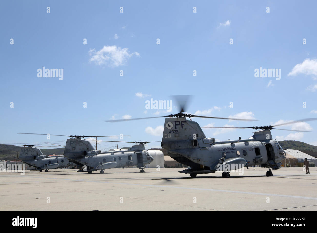 U.S. Marines with Marine Medium Helicopter Squadron (HMM) 364, Marine Aircraft Group 39, 3rd Marine Aircraft Wing (MAW), prepare CH-46E Sea Knight helicopters for flight at Camp Pendleton, Calif., March 31, 2014. After 47 years of flying the CH-46, HMM-364, “Flies the Barn”, taking off and landing in unison and flying in mass formations, signifying the transition to the MV-22 Osprey. (U.S. Marine Corps photo by Sgt. Keonaona C. Paulo, 3rd MAW Combat Camera/Released) Purple Foxes 'Fly the Barn' 140331-M-EF955-012 Stock Photo