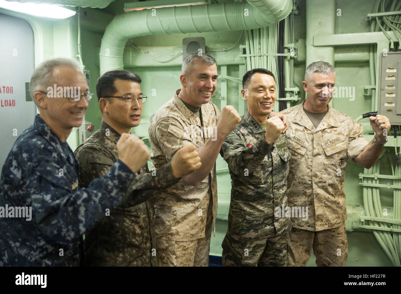 From left, U.S. Navy Rear Adm. Hugh Weatherald, Republic of Korea Navy Rear Adm. Swo Chun Jung, U.S. Marine Lt. Gen. John Wissler, ROK Marine Brig. Gen. Cho Kang Rae and U.S. Marine Brig. Gen. Paul Kennedy pose for a group photo March 31 after a press conference with civilian media to discuss Ssang Yong 2014 on the USS Bonhomme Richard off the coast of Republic of Korea. Ssang Yong, which means 'twin dragons,' representing the U.S. and ROK forces, is intended to strengthen ROK-U.S. combat readiness and combined interoperability and advance the ROK Marine Corps Marine Task Force and command and Stock Photo
