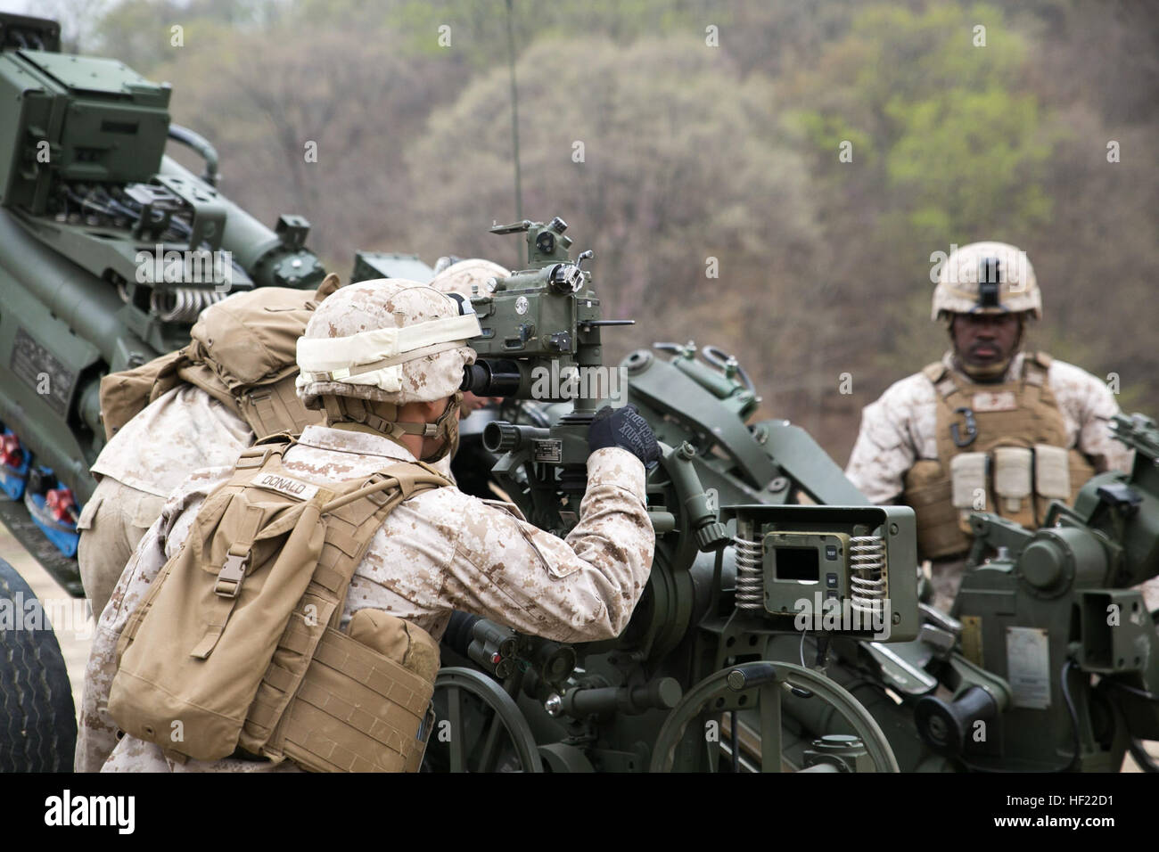 Cpl. Chase Studt checks the calibration of a M777A2 lightweight 155 mm howitzer during a live-fire training April 3 at Su Seung-ri Range in the Republic of Korea as part of Exercise Ssang Yong 2014. Ssang Yong is an exercise that showcases the amphibious and expeditionary capabilities of the ROK and U.S. forces as well as the maturity of the relationship between the two nations. Studt, a native of Cedar Rapids, Iowa, is a field artillery cannoneer with Golf Battery, 2nd Battalion, 11th Marine Regiment currently assigned to Battalion Landing Team 2nd Bn., 5th Marines, 31st Marine Expeditionary  Stock Photo