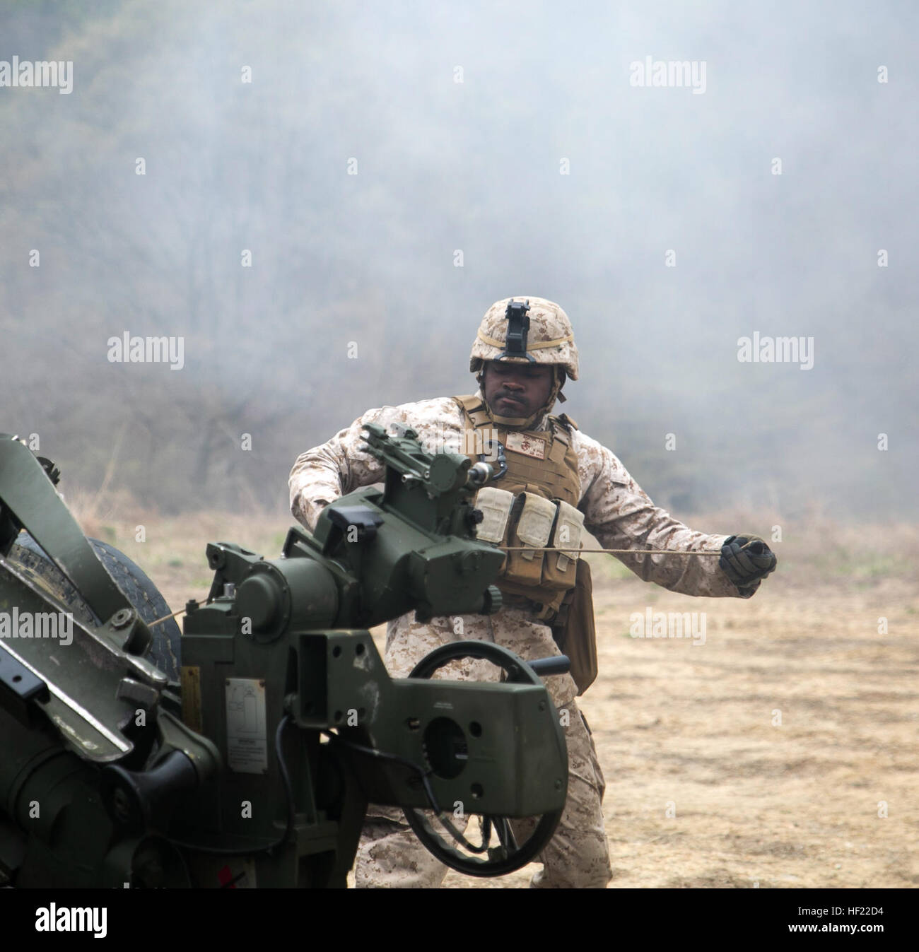 Cpl. Andre Baxter pulls the cord to fire off an M777A2 lightweight 155 mm howitzers April 3 at Su Seung-ri Range in the Republic of Korea as part of Exercise Ssang Yong 2014 The Marines shot off a total of 40 rounds between four weapons in less than five minutes. Ssang Yong is an exercise that showcases the amphibious and expeditionary capabilities of the ROK and U.S. forces as well as the maturity of the relationship between the two nations. Baxter, a native of New York City, is a field artillery cannoneer with Golf Battery, 2nd Battalion, 11th Marine Regiment currently assigned to Battalion  Stock Photo