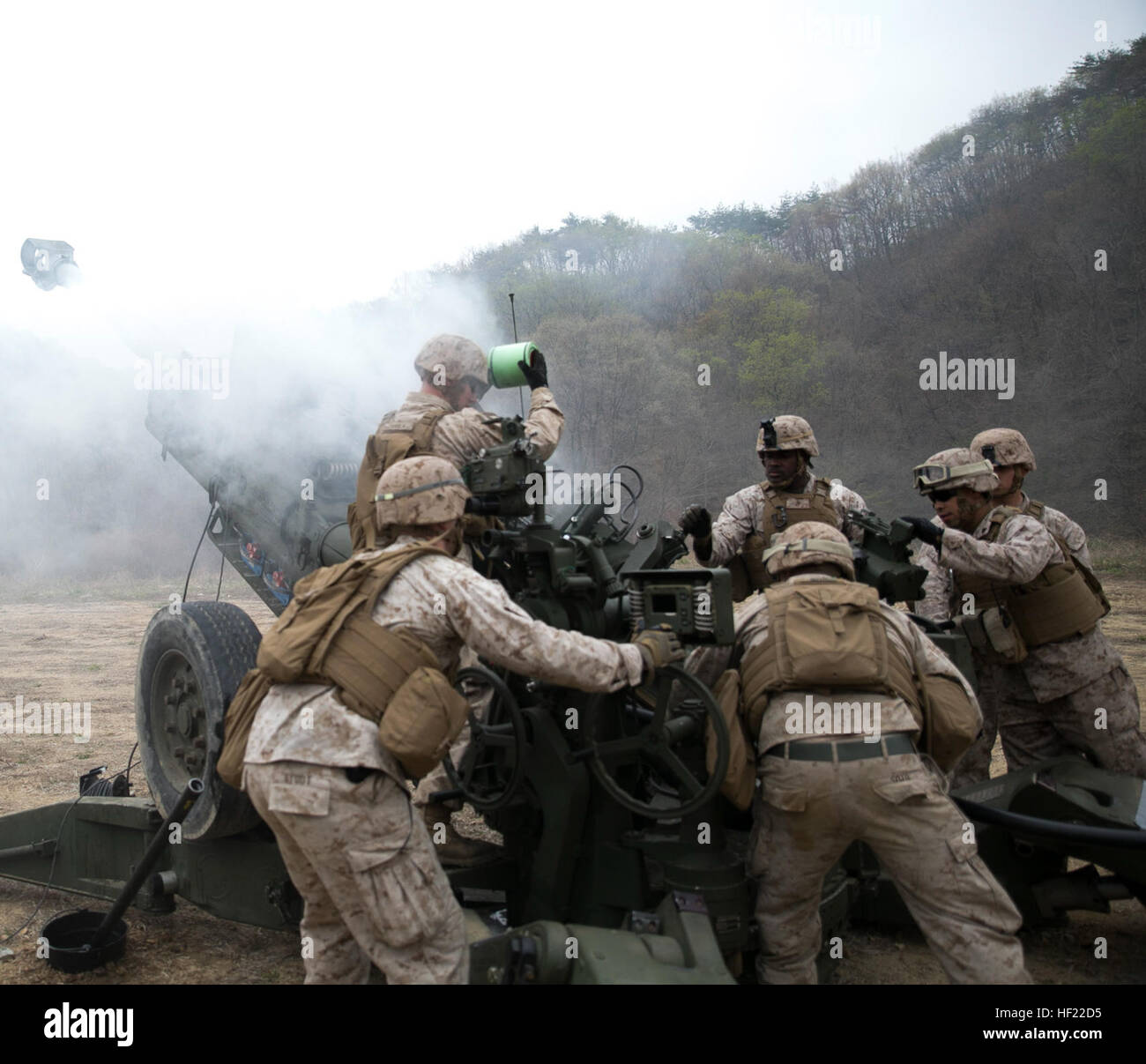 Artillery Marines fire off rounds from M777A2 lightweight 155 mm howitzers April 3 at Su Seung-ri Range in the Republic of Korea as part of Exercise Ssang Yong 2014. The Marines shot off eight rounds during the calibration portion of the live-fire, followed by another 40 rounds in succession. Ssang Yong is an exercise that showcases the amphibious and expeditionary capabilities of the ROK and U.S. forces as well as the maturity of the relationship between the two nations. The Marines are with Golf Battery, 2nd Battalion, 11th Marine Regiment currently assigned to Battalion Landing Team 2nd Bn. Stock Photo