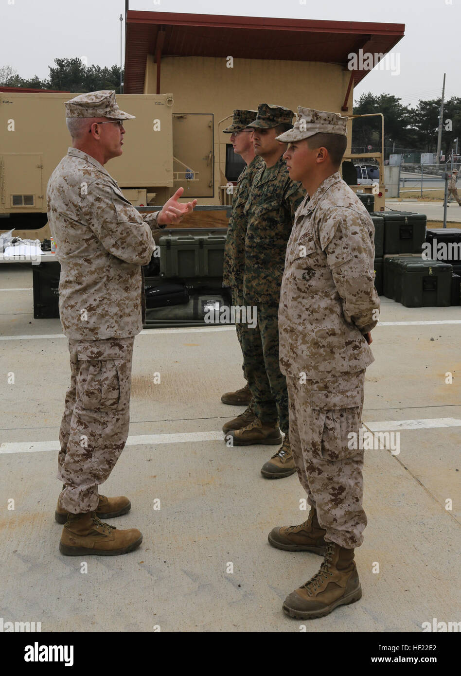 Maj. Gen. James S. Hartsell, Commanding General of 4th Marine Division, awards a coin to three Marines with Delta Battery, 2d Battalion, 14th Marine Regiment during exercise Ssang Yong, Pohang, South Korea,  April 3, 2014. Coin award, Ssang Yong 14 140403-M-GZ082-007 Stock Photo