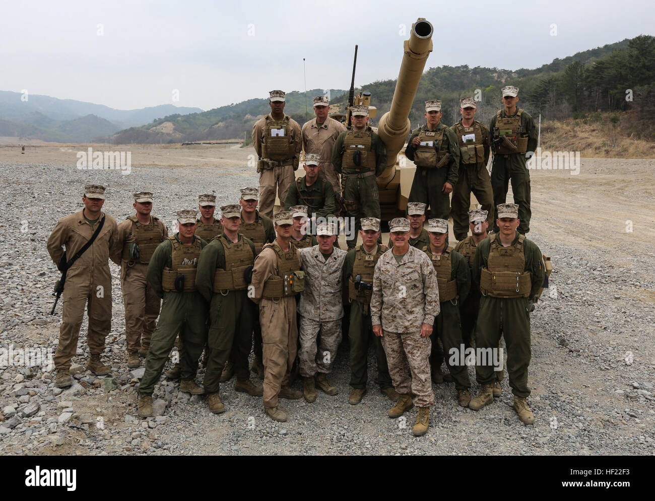 Maj. Gen. James S. Hartsell and Sgt. Maj. Bradley Kasal, Commanding General and Sergenat Major of 4th Marine Division, pose for a photo with Marine with Charlie Company, 4th Tanks Battalion, participating in exercise Ssang Yong, Pohang, South Korea,  April 3, 2014. Exercise Ssang Yong is conducted annually in the ROK to enhance interoperability between U.S. and ROK forces by performing a full spectrum of amphibious operations while showcasing sea-based power projection in the Pacific. (U.S. Marine Corps photo by Cpl. Lauren Whitney/Released) 4th Marine Division leaders visit, Ssang Yong 14 140 Stock Photo