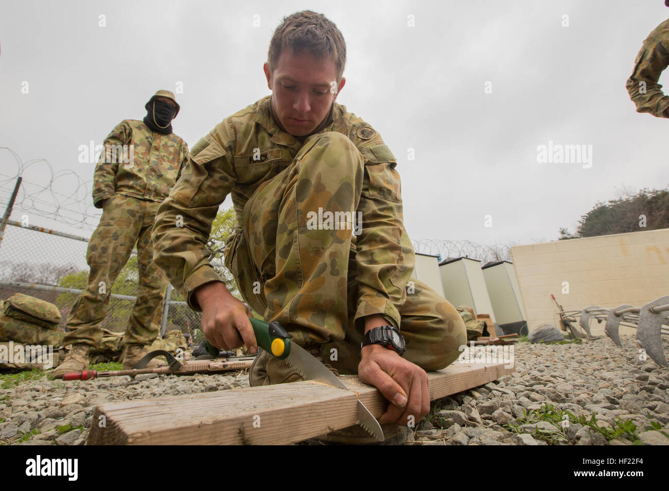 Royal Australian Army Sapper Tim Flack, Combat Engineer, with 2nd Combat Engineer Regiment, 7th Brigade, saws a piece of wood to construct a make shift bridge in order to hone engineering skills, during Exercise Ssang Yong 14 at Ranger Training Site, Pohang, South Korea, April 3, 2014. Exercise Ssang Yong 14 is conducted annually in the Republic of Korea (ROK) to enhance interoperability between U.S. and ROK forces by performing a full spectrum of amphibious operations while showcasing sea-based power projection in the Pacific. (U.S. Marine Corps Photo by Lance Cpl. Tyler S. Dietrich/ Released Stock Photo