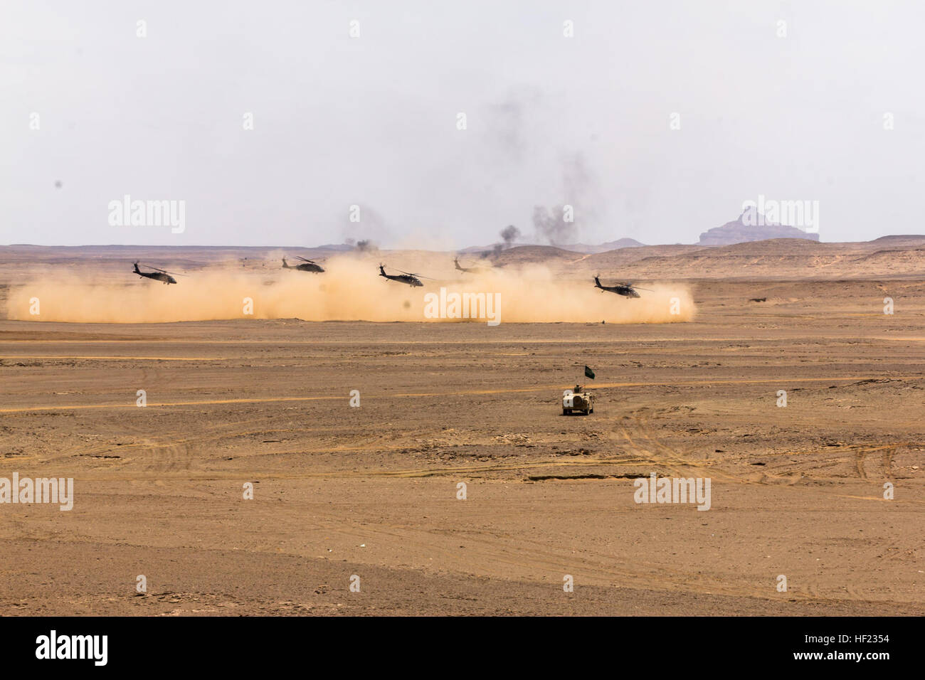 UH-60 Black Hawks flown by Company A, 3rd Battalion, 238th General Support Aviation Battalion, 42nd Combat Aviation Brigade (CAB), and the Royal Saudi Land Forces (RSLF) 1st Battalion, 3rd Aviation Group, take off after extracting infantry during the culminating event of Exercise Friendship and Iron Hawk 14 on April 13th, 2014, near Tabuk, Saudi Arabia.  Iron Hawk and Friendship 14 involved U.S. Army forces from the 42nd CAB, New York Army National Guard, and 2nd Brigade Combat Team, 4th Infantry Division, and Saudi Arabian ground and aviation forces.  Over weeks of practice the two militaries Stock Photo