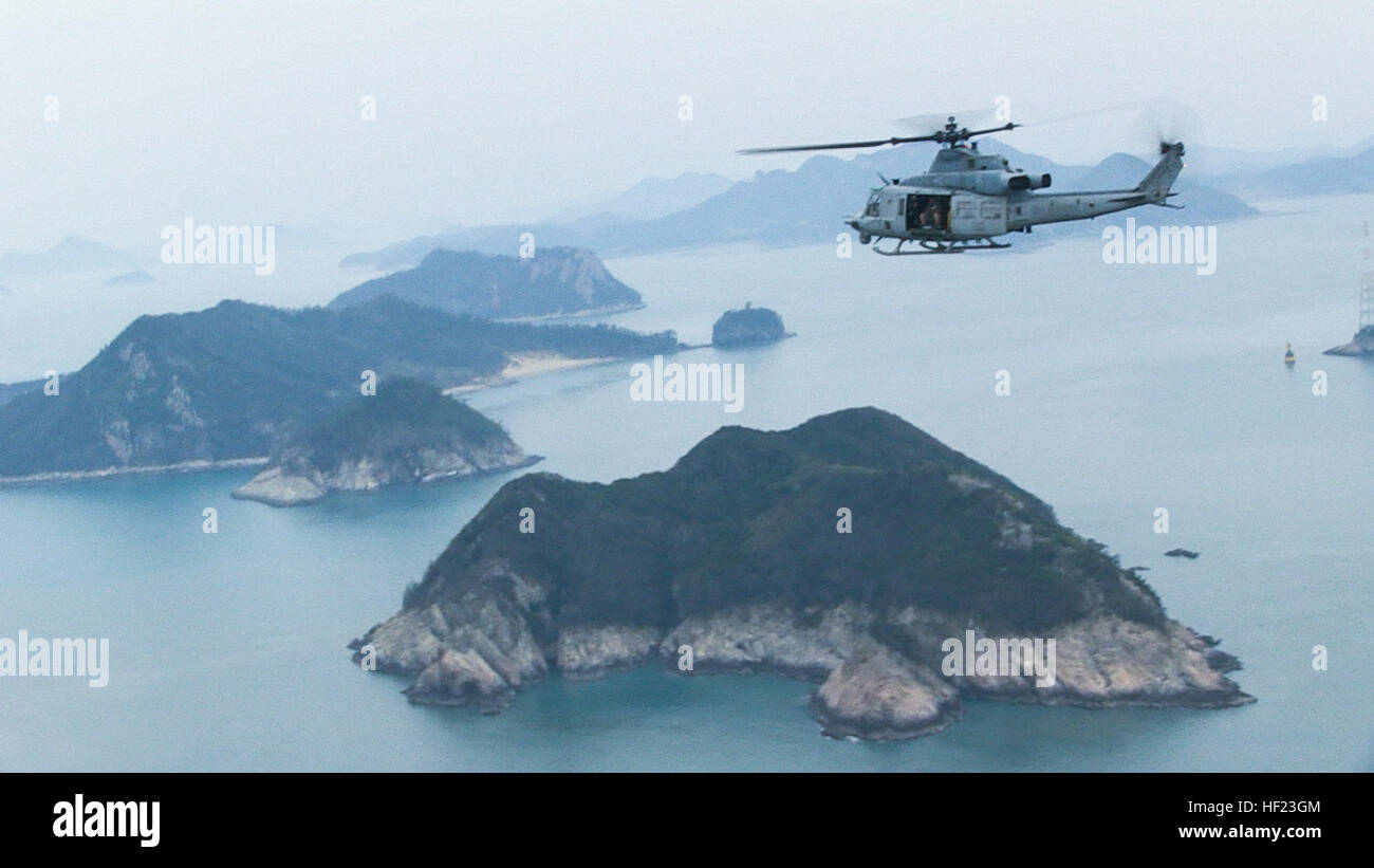 U.S. Marines in a UH-1Y Huey helicopter with Marine Medium Tiltrotor Squadron 265 (Reinforced) (VMM-265 (REIN)), 31st Marine Expeditionary Unit (31st MEU) conduct search and rescue operations for the sunken Korean ferry Sewol off the coast of the Republic of Korea.  The 31st MEU and Amphibious Squadron 11 (PHIBRON 11) had just completed participation in Exercise Ssang Yong 2014 and were roughly 100 nautical miles away when they were tasked to respond to the incident April 16.  The 31st MEU and PHIBRON 11 provide a forward deployed maritime contingency response force capable of conducting a wid Stock Photo