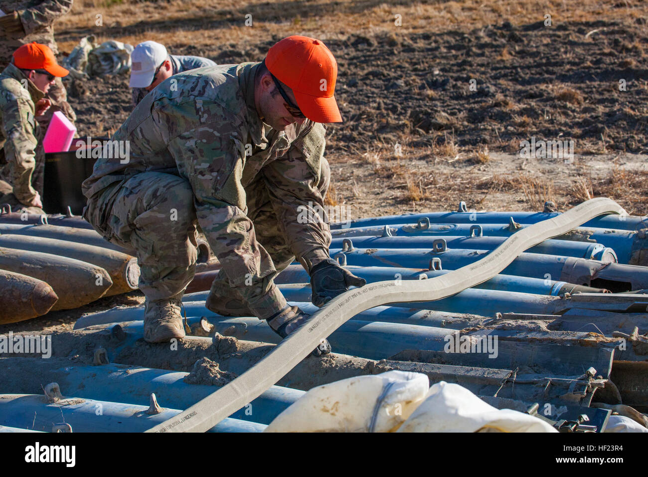 An Explosive Ordnance Disposal (EOD) Airman adjusts explosive cutting