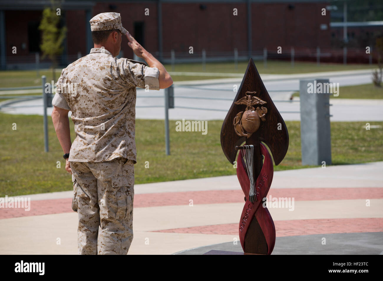 A Critical Skill Operator, with U.S. Marine Corps Forces Special Operations Command, renders a salute, after gently hanging the dog tags of one of his fallen comrades on the MARSOC Honor the Fallen memorial, during 'Honor the Fallen,' a one-of-a-kind event, April 25, at the MARSOC headquarters, to honor all Marines, sailors and civilian Marines lost at home and abroad since MARSOC's inception. 'Honor the Fallen is about honoring and reflecting upon the memory and life of all of our fallen MARSOC Marines and sailors to include all civilians who have served with MARSOC in any capacity, and the r Stock Photo