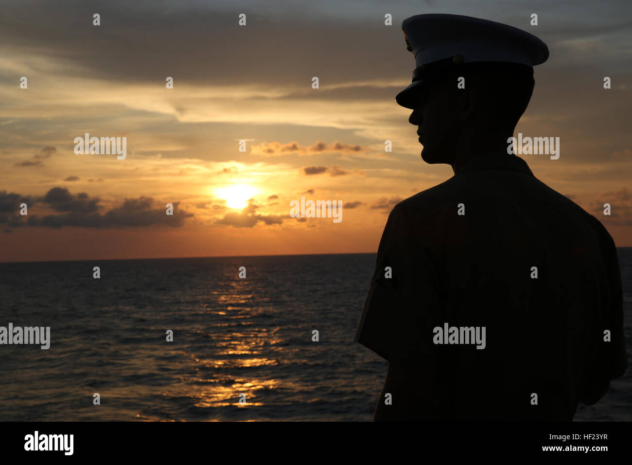 Lance Cpl. Ethan C. Hogeland, native of Fayetteville, N.C., and amphibious assault vehicle crewman with 2nd Assault Amphibian Battalion, 2nd Marine Division, Marine Corps Base Camp Lejeune, N.C., watches the sunrise on the flight deck in preparation for manning the rails as the USS New York (LPD 21) sails into South Florida for Fleet Week Port Everglades 2014, April 28. Approximately 120 Marines from 2nd AAV Bn., 2nd Battalion, 6th Marine Regiment, 2nd Marine Division, Marine Corps Base Camp Lejeune, N.C., and Marine Light Attack Helicopter Squadron (HMLA) 269, Marine Corps Air Station New Riv Stock Photo