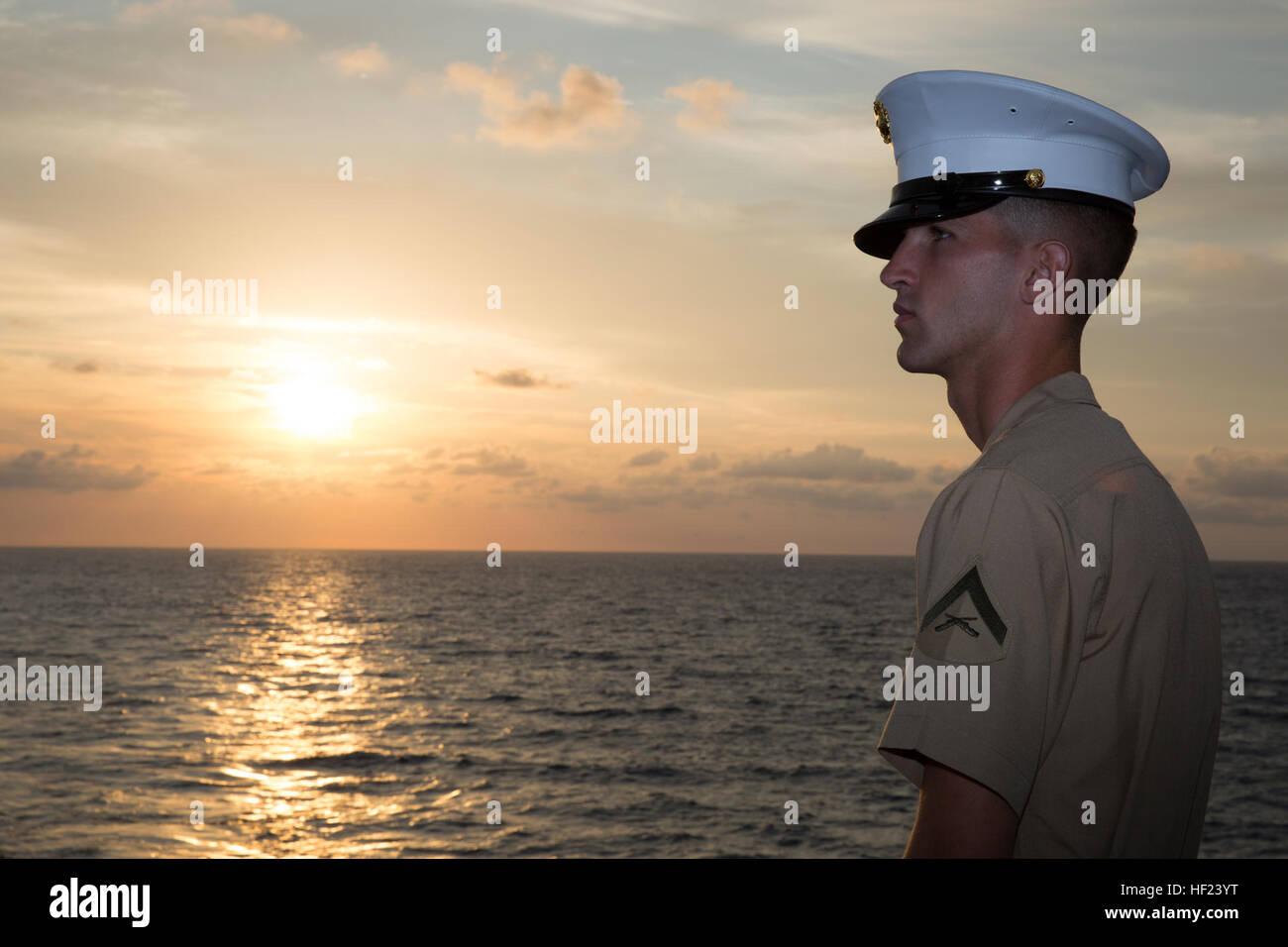 Lance Cpl. Ethan C. Hogeland, native of Fayetteville, N.C., and amphibious assault vehicle crewman with 2nd Assault Amphibian Battalion, 2nd Marine Division, Marine Corps Base Camp Lejeune, N.C., watches the sunrise on the flight deck in preparation for manning the rails as the USS New York (LPD 21) sails into South Florida for Fleet Week Port Everglades 2014, April 28. Approximately 120 Marines from 2nd AAV Bn., 2nd Battalion, 6th Marine Regiment, 2nd Marine Division, Marine Corps Base Camp Lejeune, N.C., and Marine Light Attack Helicopter Squadron (HMLA) 269, Marine Corps Air Station New Riv Stock Photo